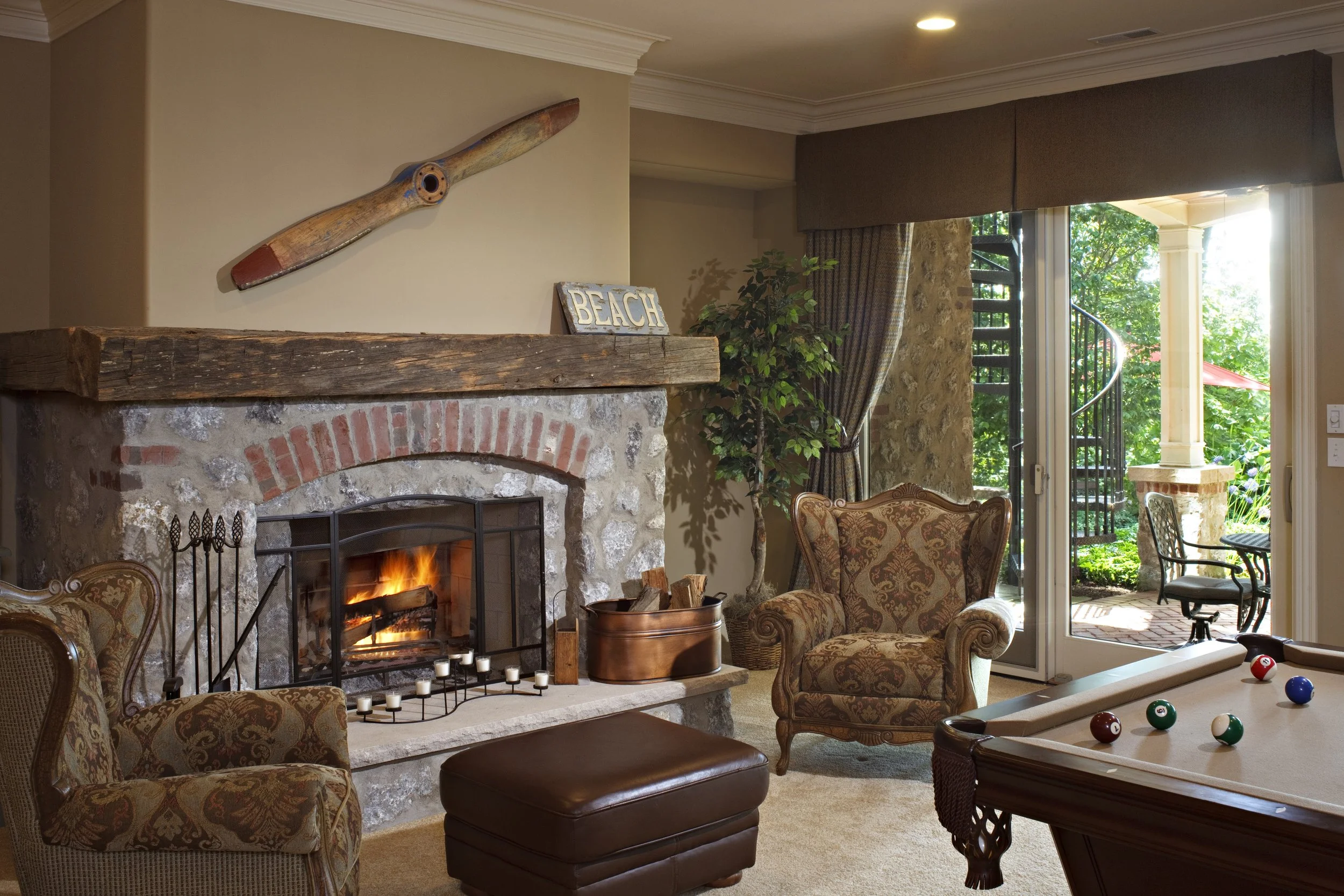 Oklahoma Boulder Fireplace by Southampton Builders LLC. in St. Charles IL.  Custom Timber Mantle.  