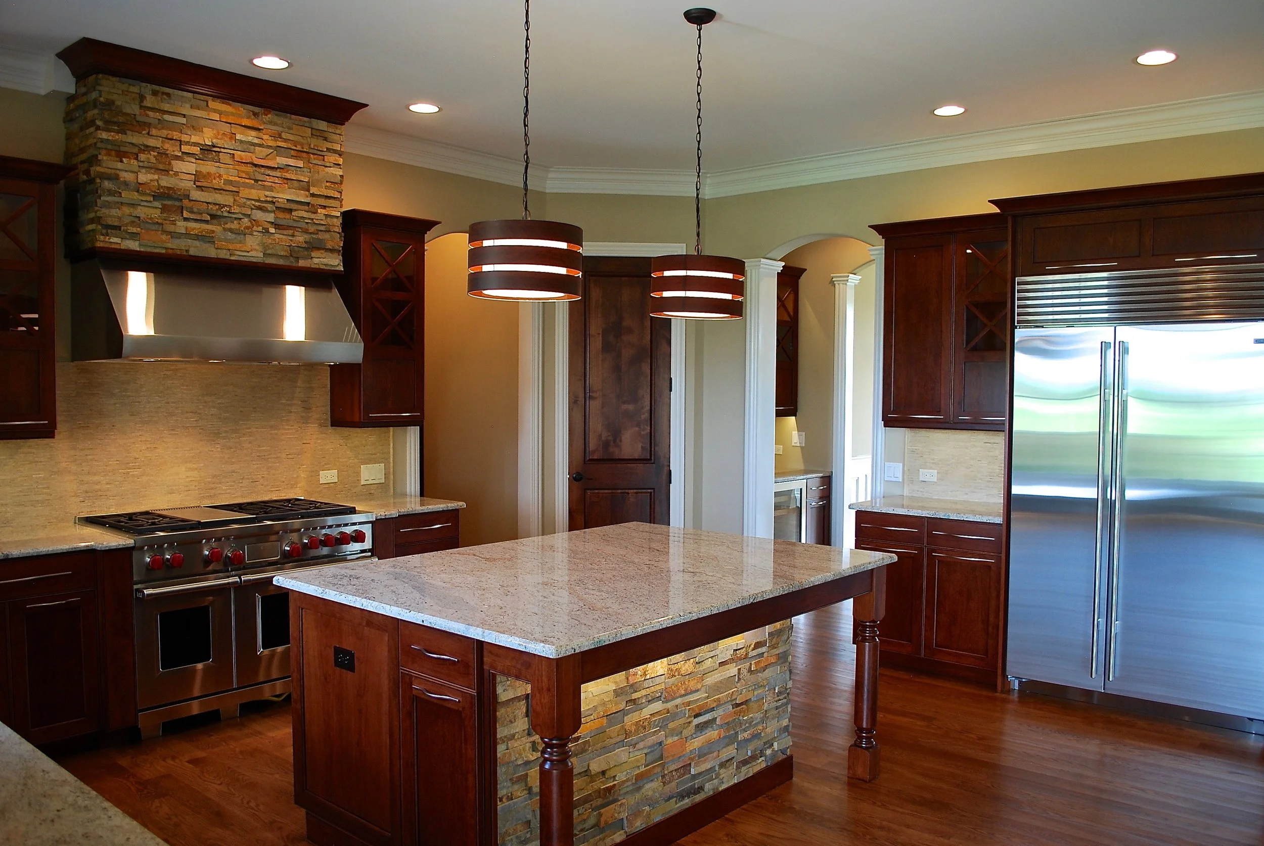 Custom Stone Hood. Custom Stone Island. 48" Sub Zero Fridge. Wide Cabinet Pulls. Prairie Lakes St. Charles IL. 