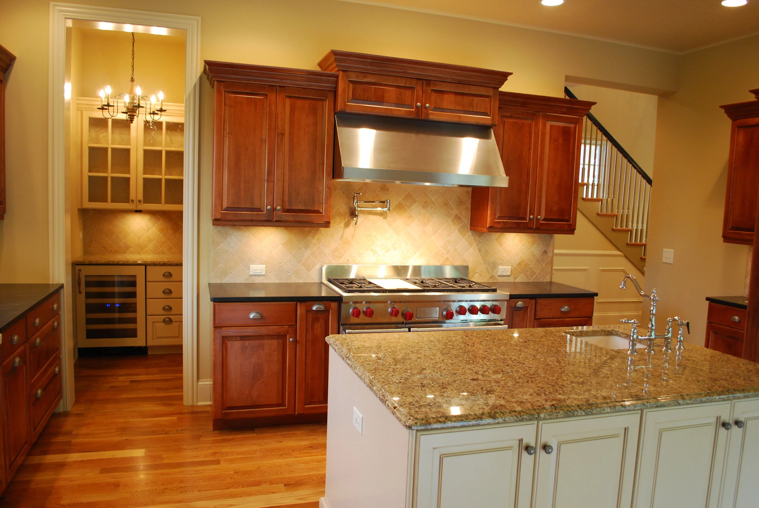 Wolf 48" Dual Fuel Range. Sub Zero Wine Fridge with Glass Door. Painted Island. New Venetian Granite Counters. St. Charles IL Remodeling