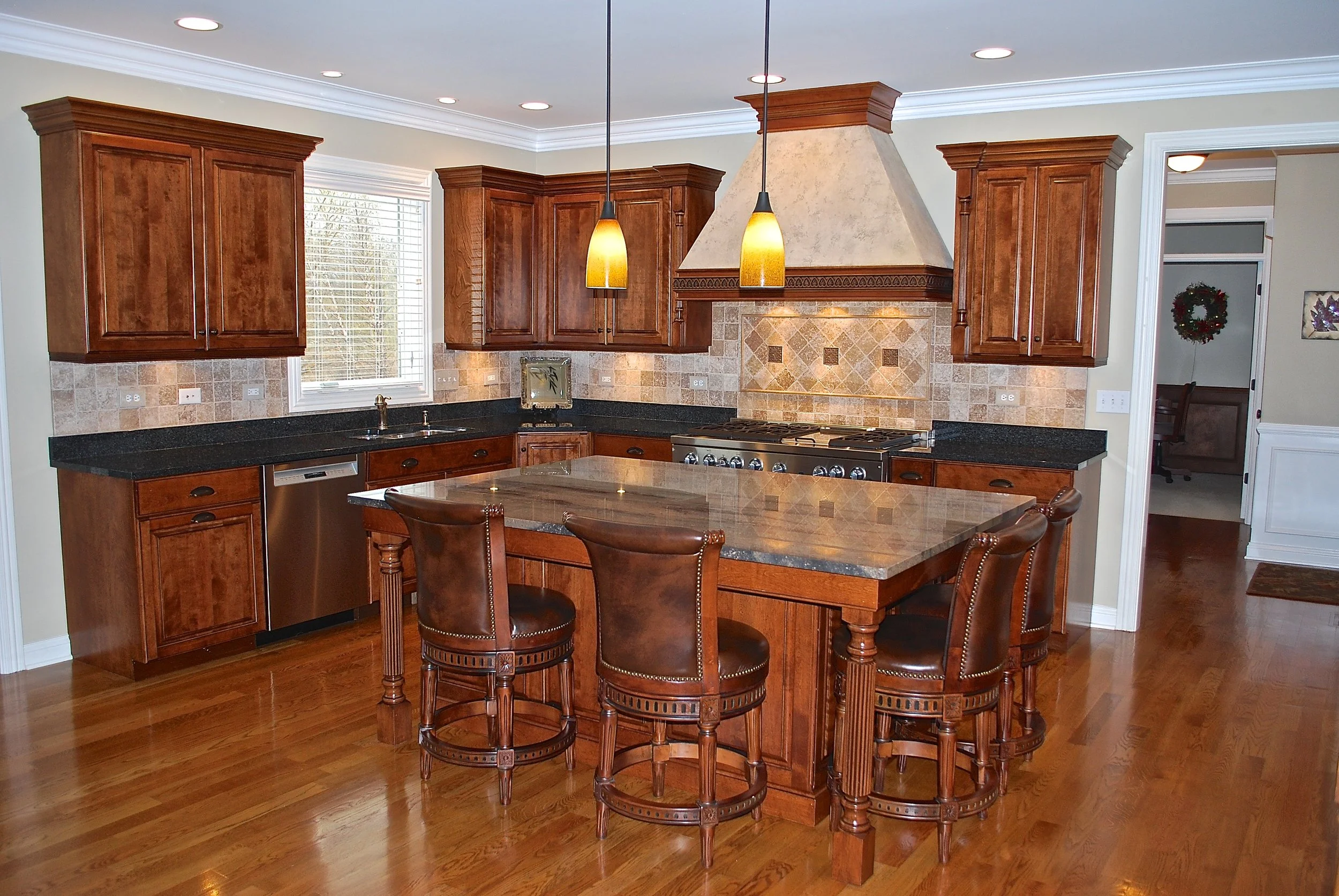 Custom Hood Faux Painting.  Island Seating for Four.  Green Granite. Reeded Island Legs.  Custom Kitchen Remodel in St. Charles IL 60174