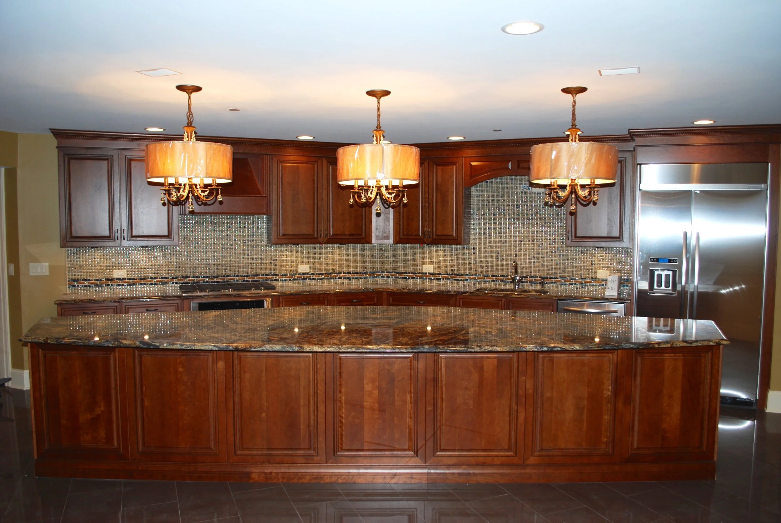 Luxury Basement Kitchen in Oakbrook IL. Large Basement Island. Kitchen Aid Appliances. Drum Lighting. By Southampton Builders LLC.