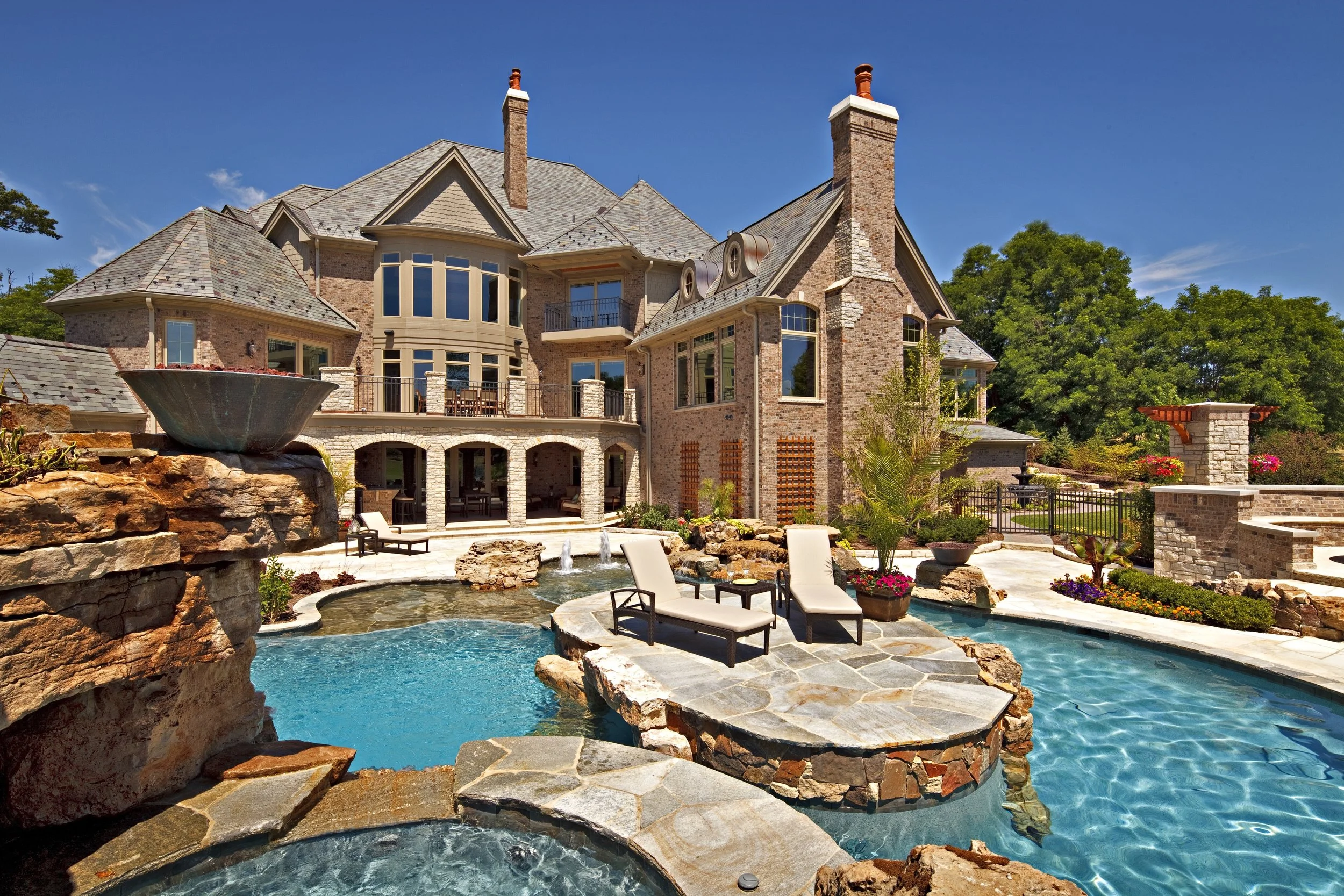 Stone Hot Tub Overlooking Pool Island.  Dream Pool & Outdoor Firepit.  Southampton Builders LLC. Geneva IL 60134