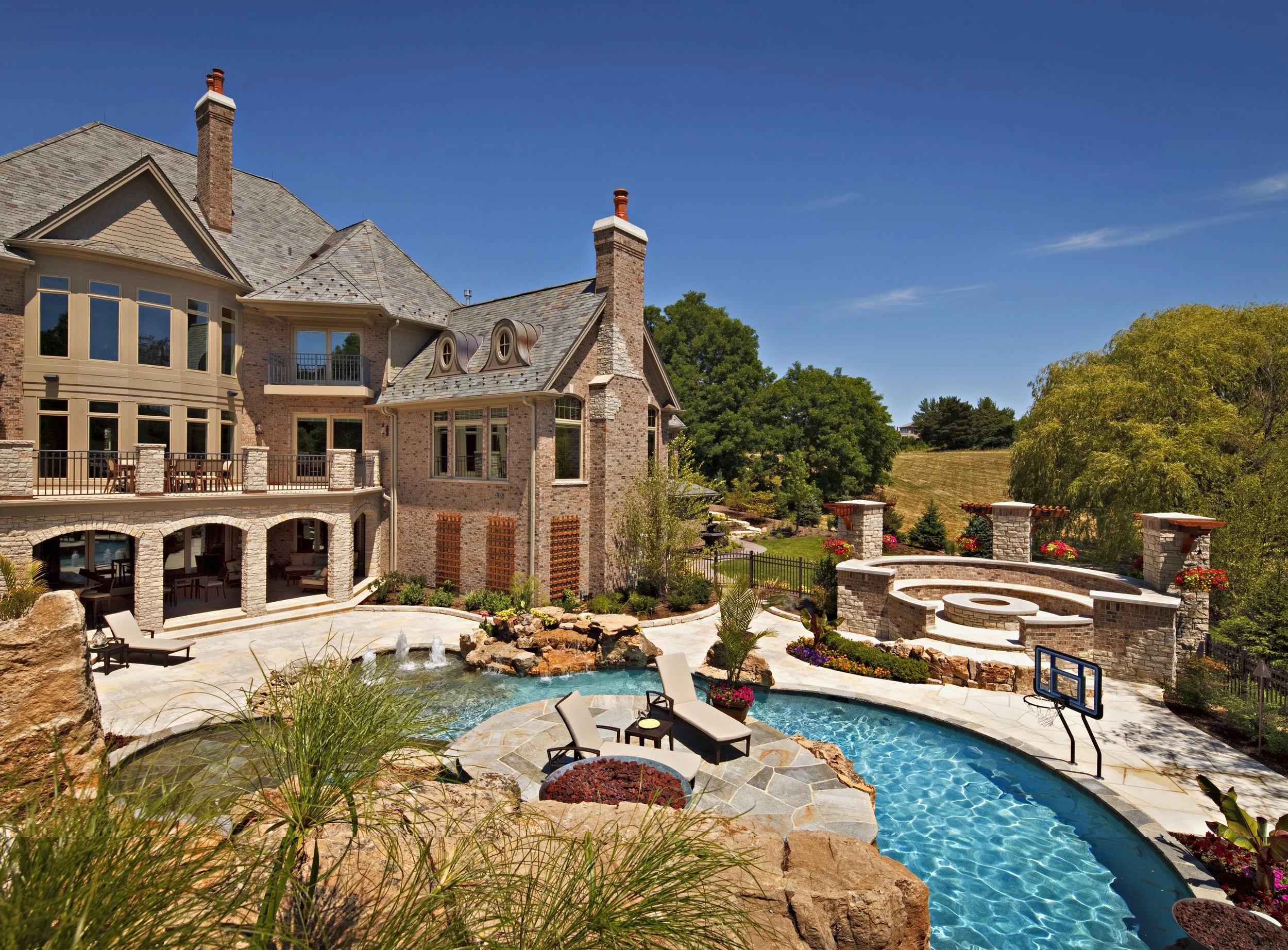 Dream Fire Pit & House.  Pool with and Island.  Luxury Home in Geneva IL by Southampton Builders. 