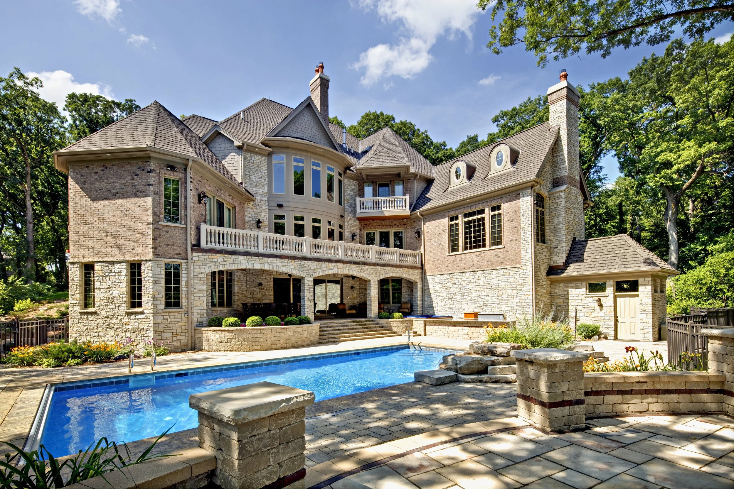 Custom Home & Pool in Woodstock IL.  Stone Veranda and Pool Bathroom.  Southampton Builders LLC.