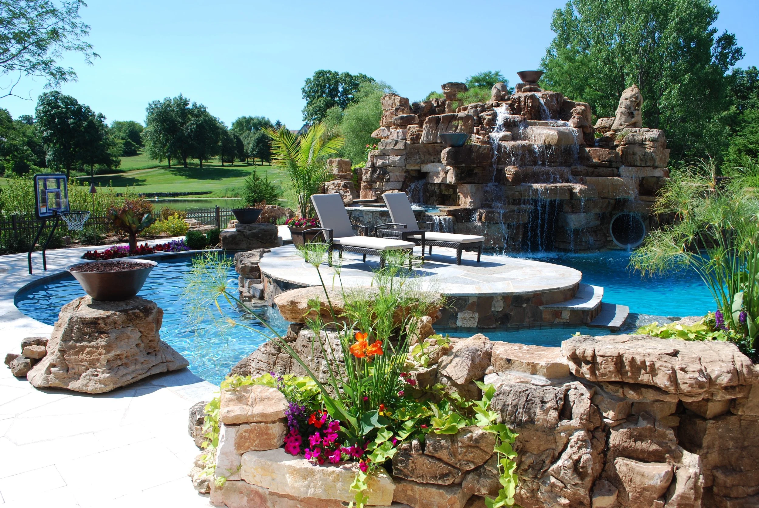 Custom Pool with Island, Firebowl, Rock Outcroppings & Rock Mountain with Slide, Hot Tube & Grotto. Southampton Builders.