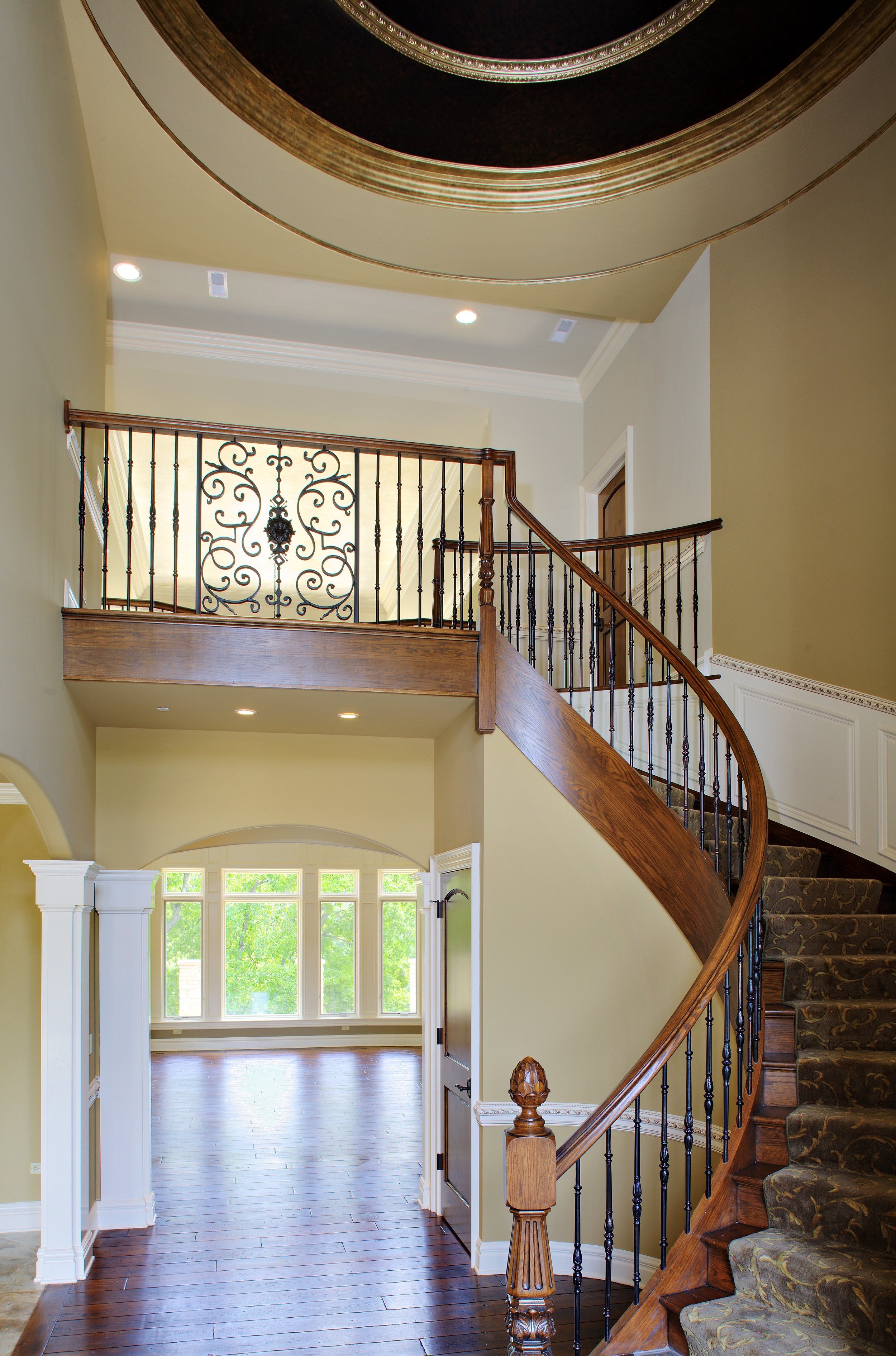 Curved Staircase in Soaring Foyer