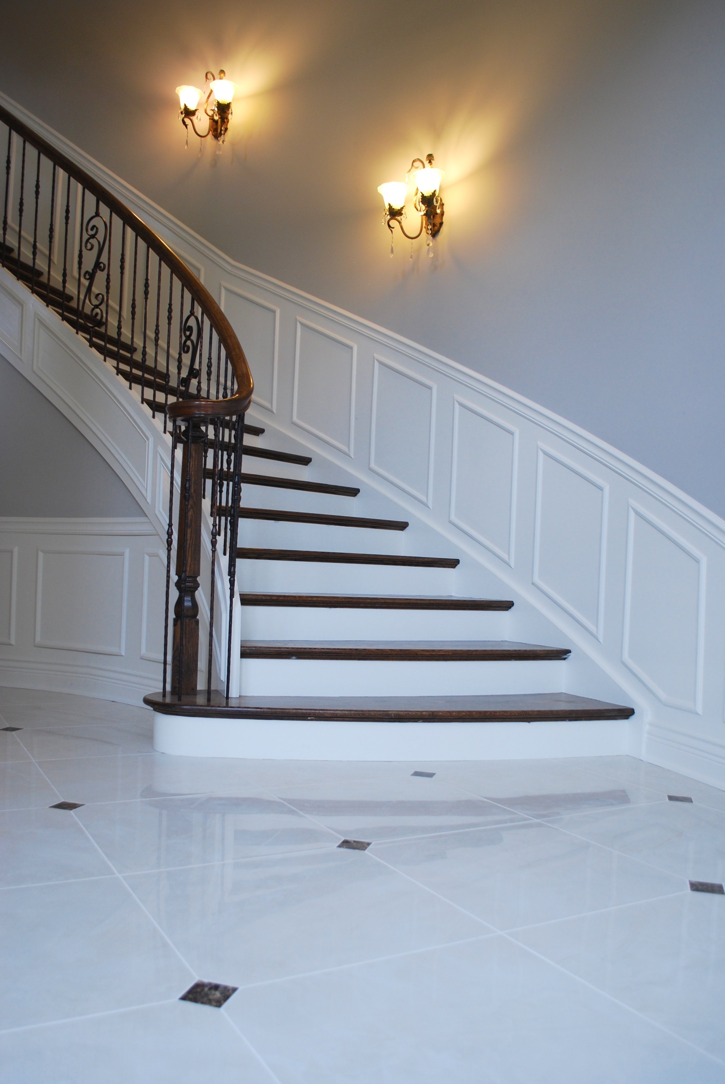 GRAND CURVED WHITE STAIR CASE WITH MARBLE FOYER