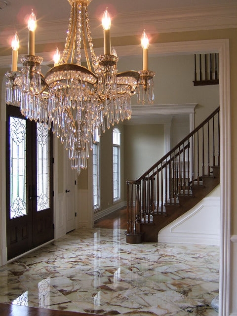Elegant Foyer with Marble Floors and Curved Staircase 