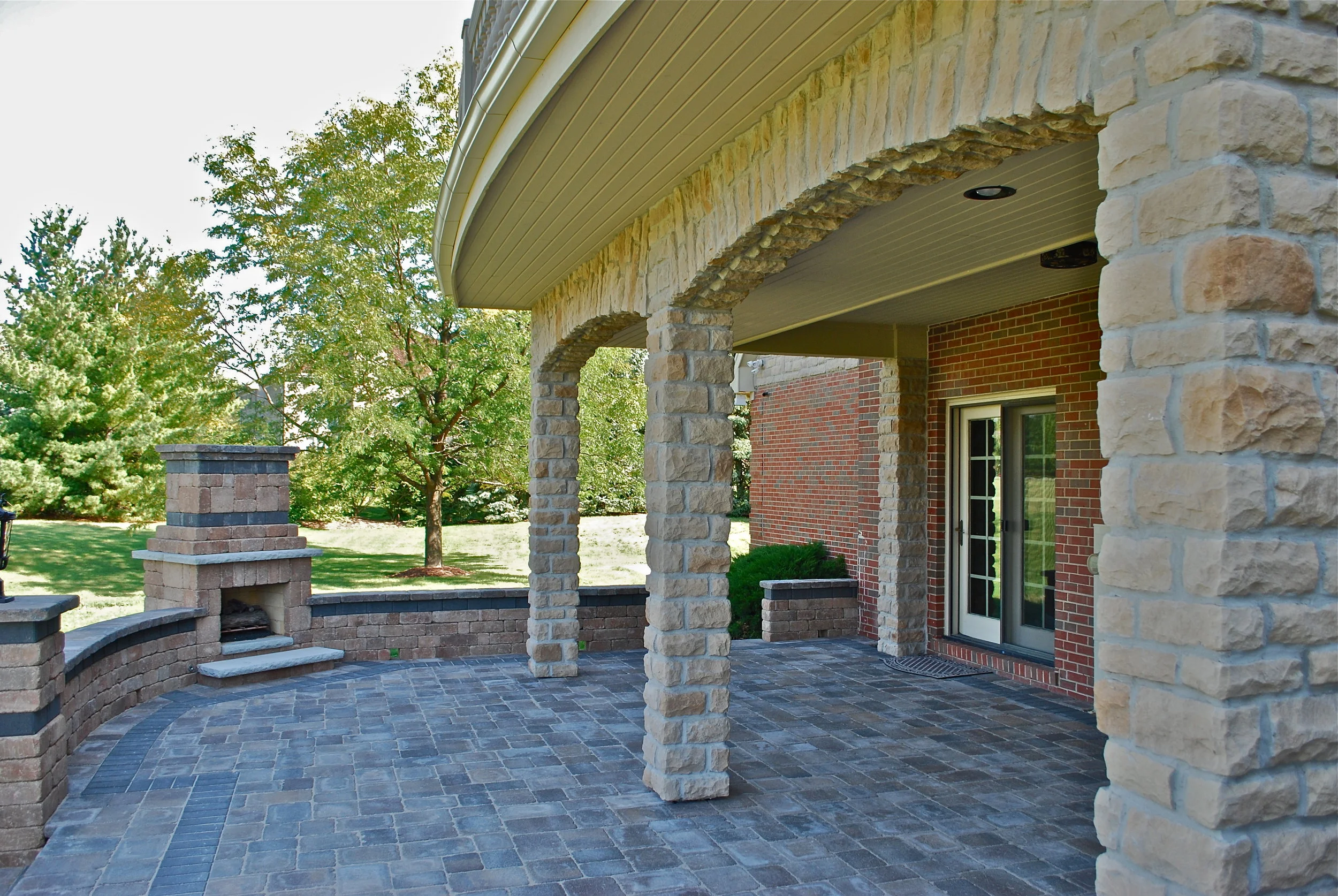 HOME ADDITIONS WITH STONE ARCHES &amp; CUSTOM UNILOCK FIREPLACE &amp; PATIO. ARCHED WATERPROOF DECK