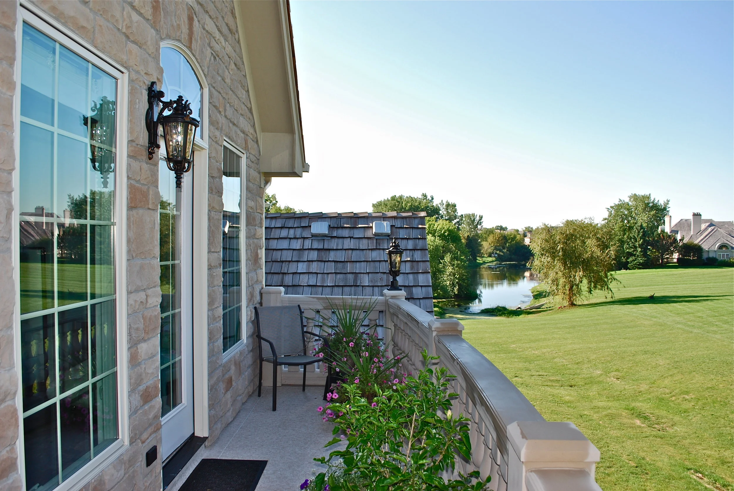 VIEW FROM THE HOME ADDITION &amp; DECK. CURVED LIMESTONE HAND RAILS &amp; BALUSTERS. BARRINGTON IL. LIMESTONE
