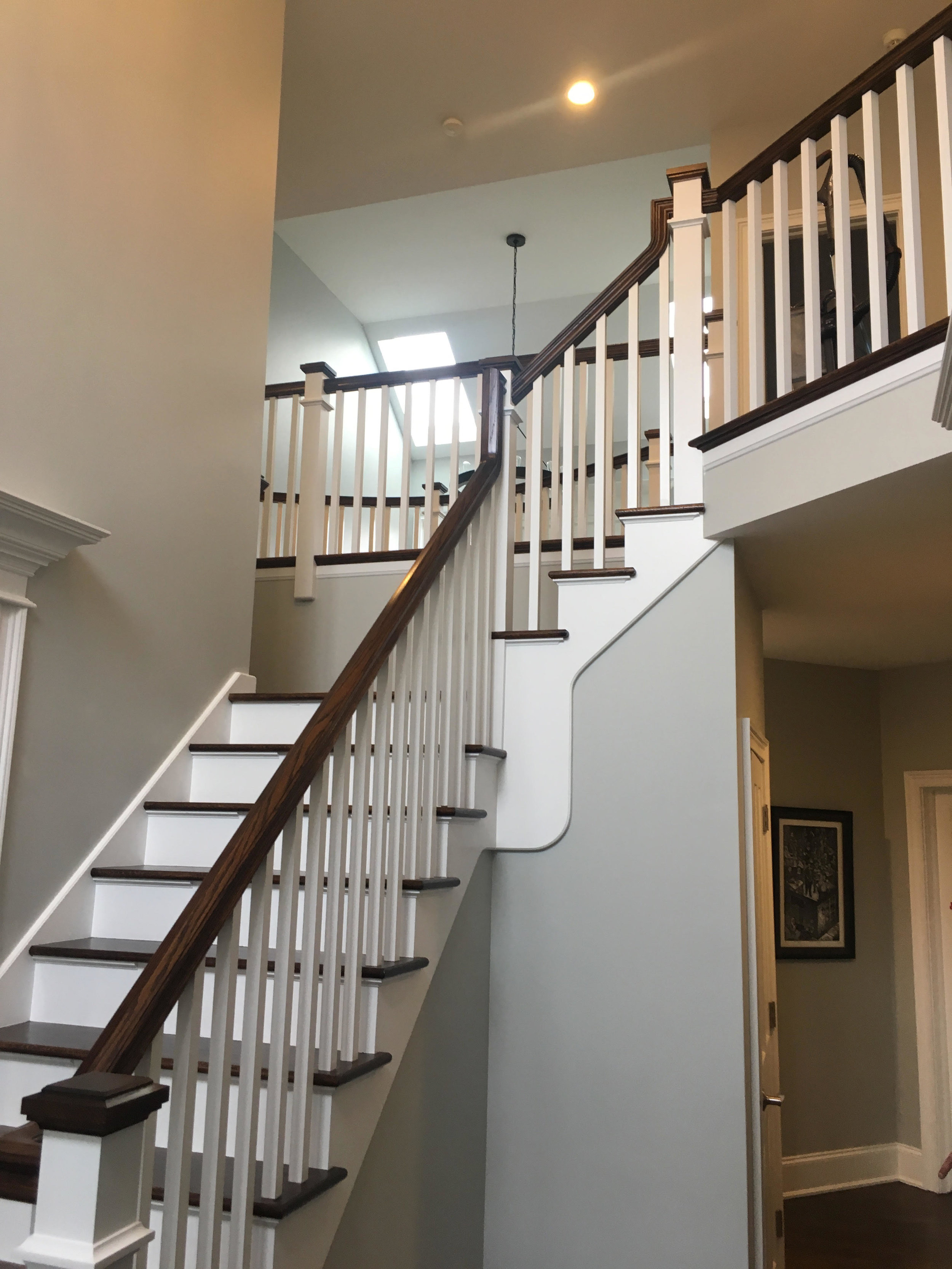 Foyer Remodeling in this Glen Ellyn Custom Home. New Handrail, Painted White, Square Spindles &amp; Square Starting Newels