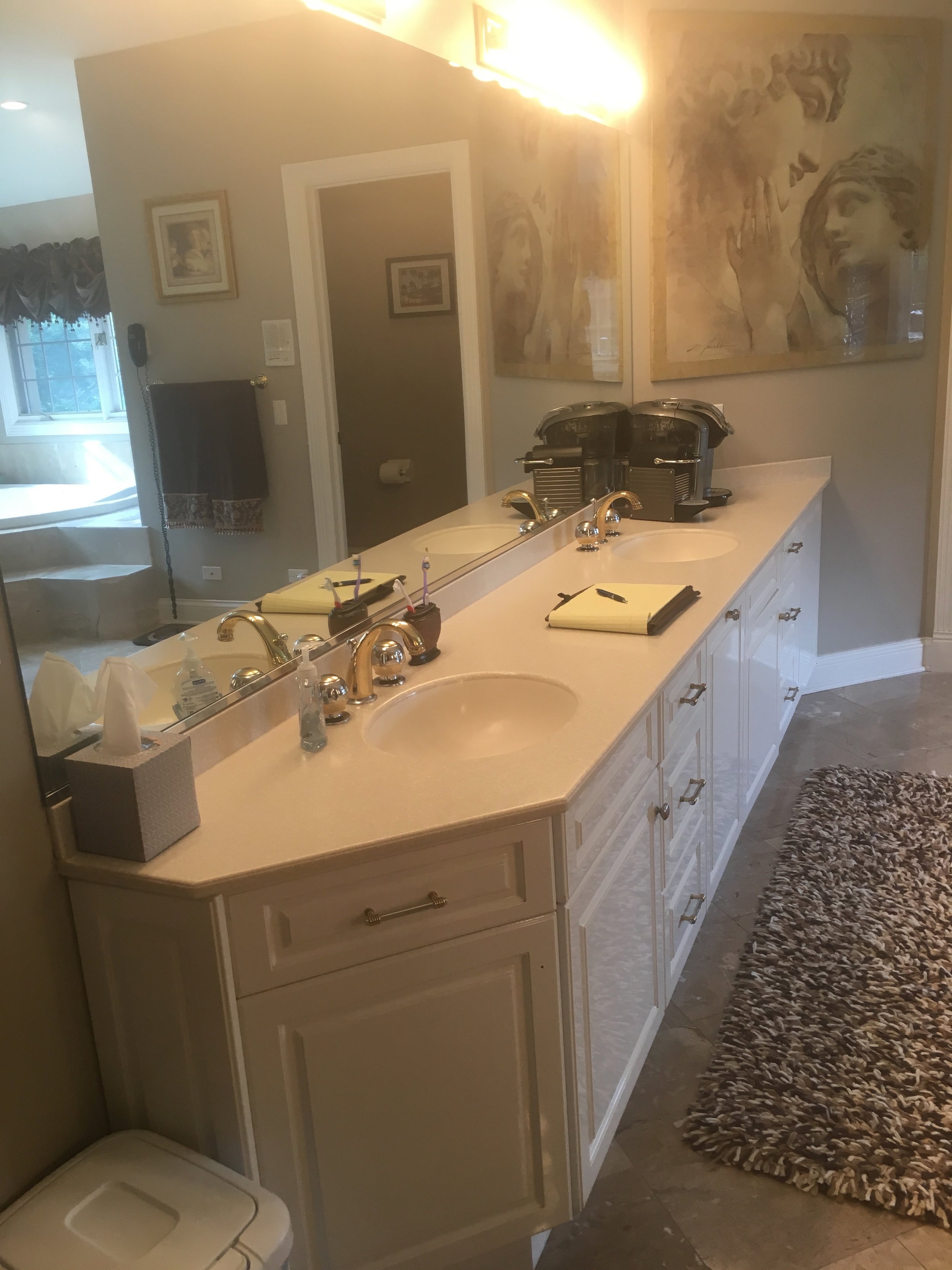 BEFORE PHOTO OF AN OUTDATED LAMINATE WHITE MASTER VANITY WITH CORIAN COUNTERS AND PLATE GLASS MIRRORS- REMODEL IN NAPERVILLE IL