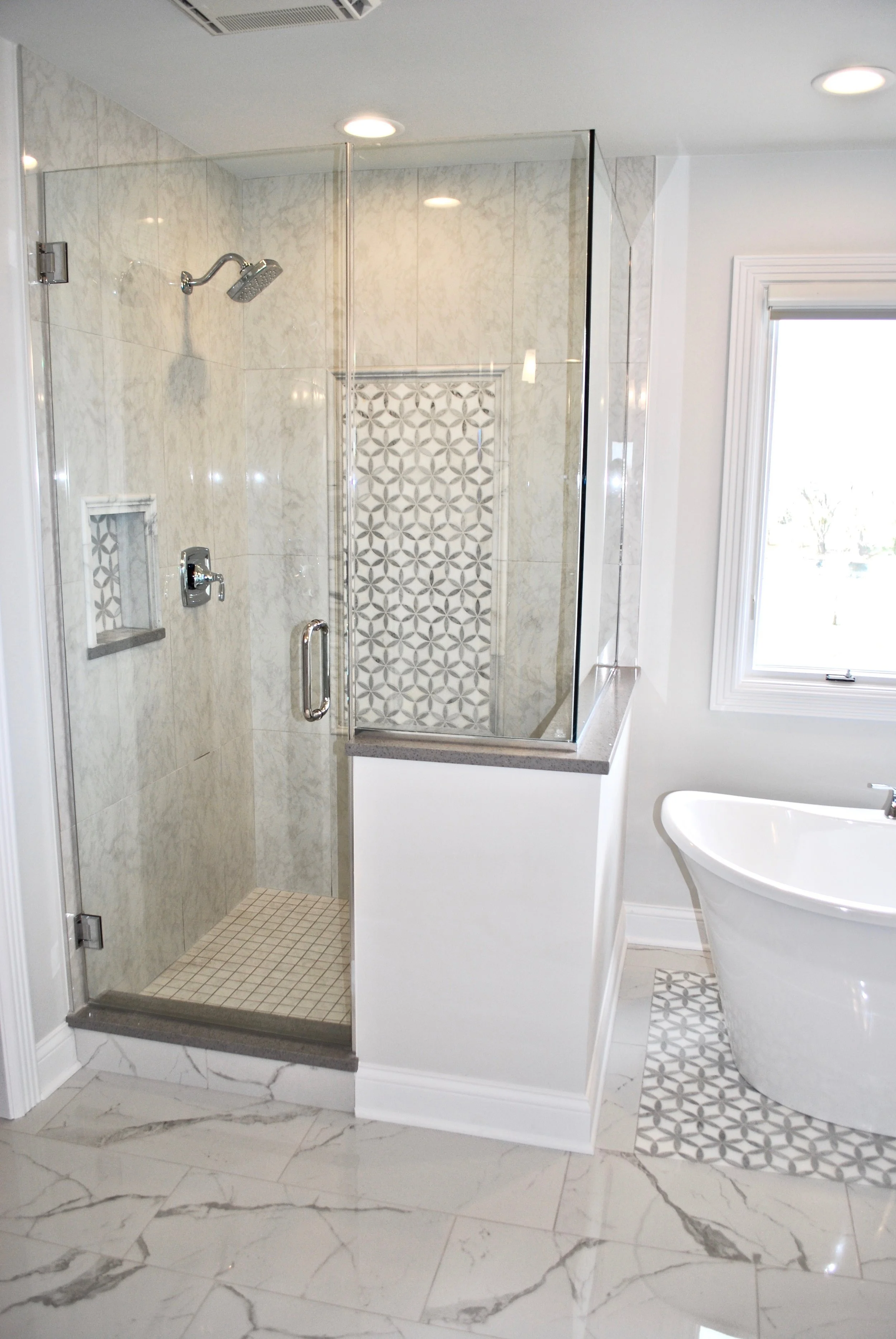 Bathroom Shower Remodeling in Naperville IL. Grey &amp; White Marble Shower with Custom Inlay and Freestanding Tub Complete this Bathroom Renovations. Looking for a Contractor Near Me? Geneva IL