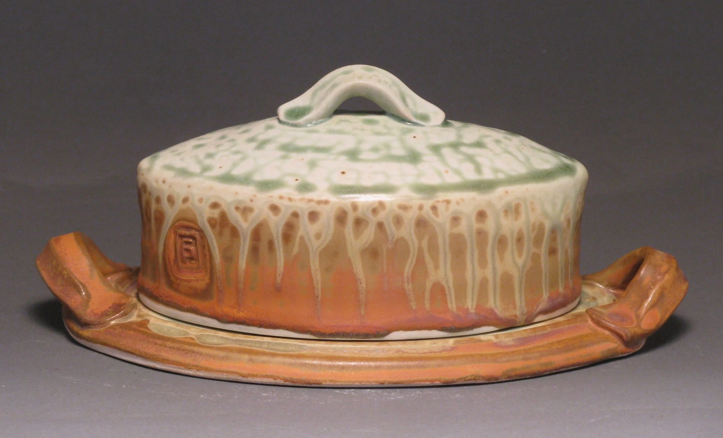Oval butter dish Glazes: green ash and matte rust