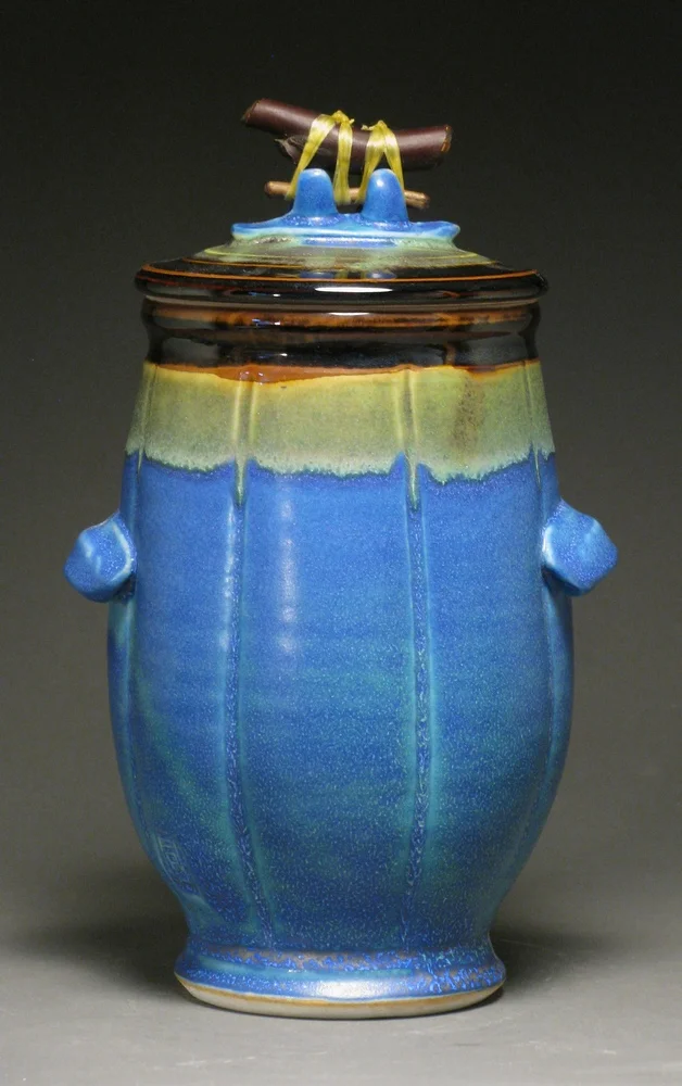 Lidded jar with manzanita handle 9" tall Glazes: matte blue and temmoku