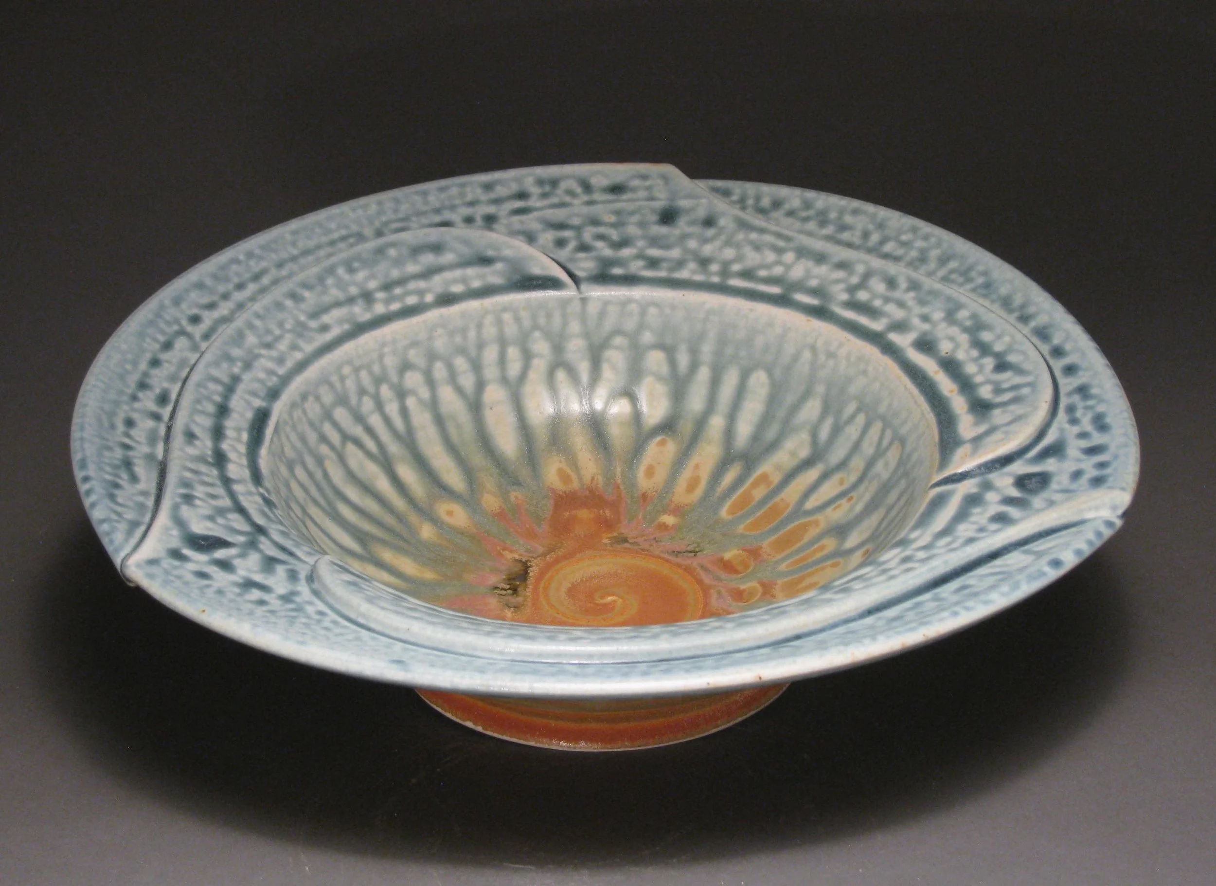 Pinwheel bowl 11" diameter Glazes: blue ash and matte rust