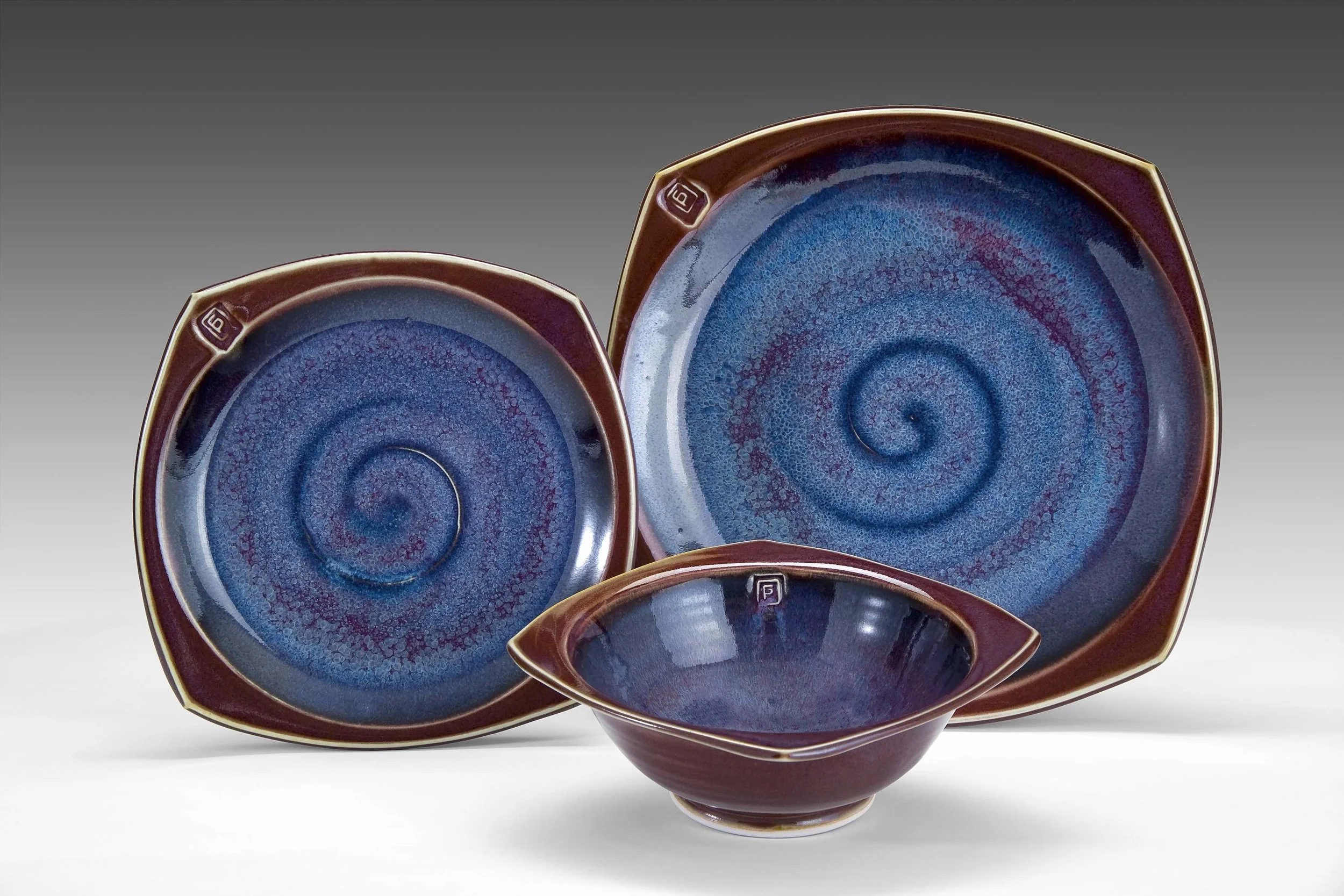 Place setting--squared border Glazes: purple haze and copper red