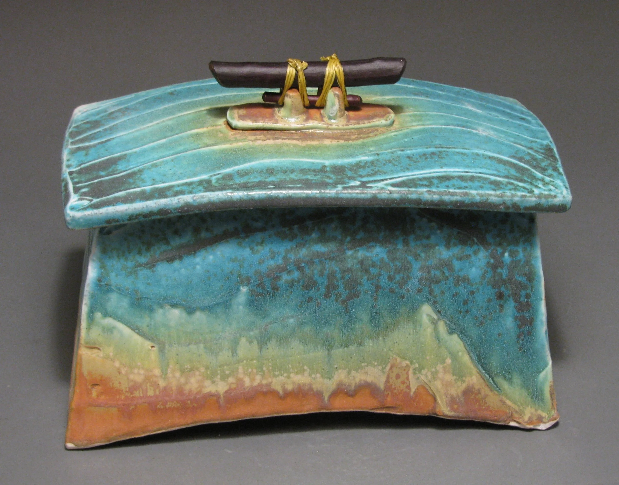 Lidded box 7" tall by 10" long by 5 1/2" wide Glazes: Matte turquoise and matte rust