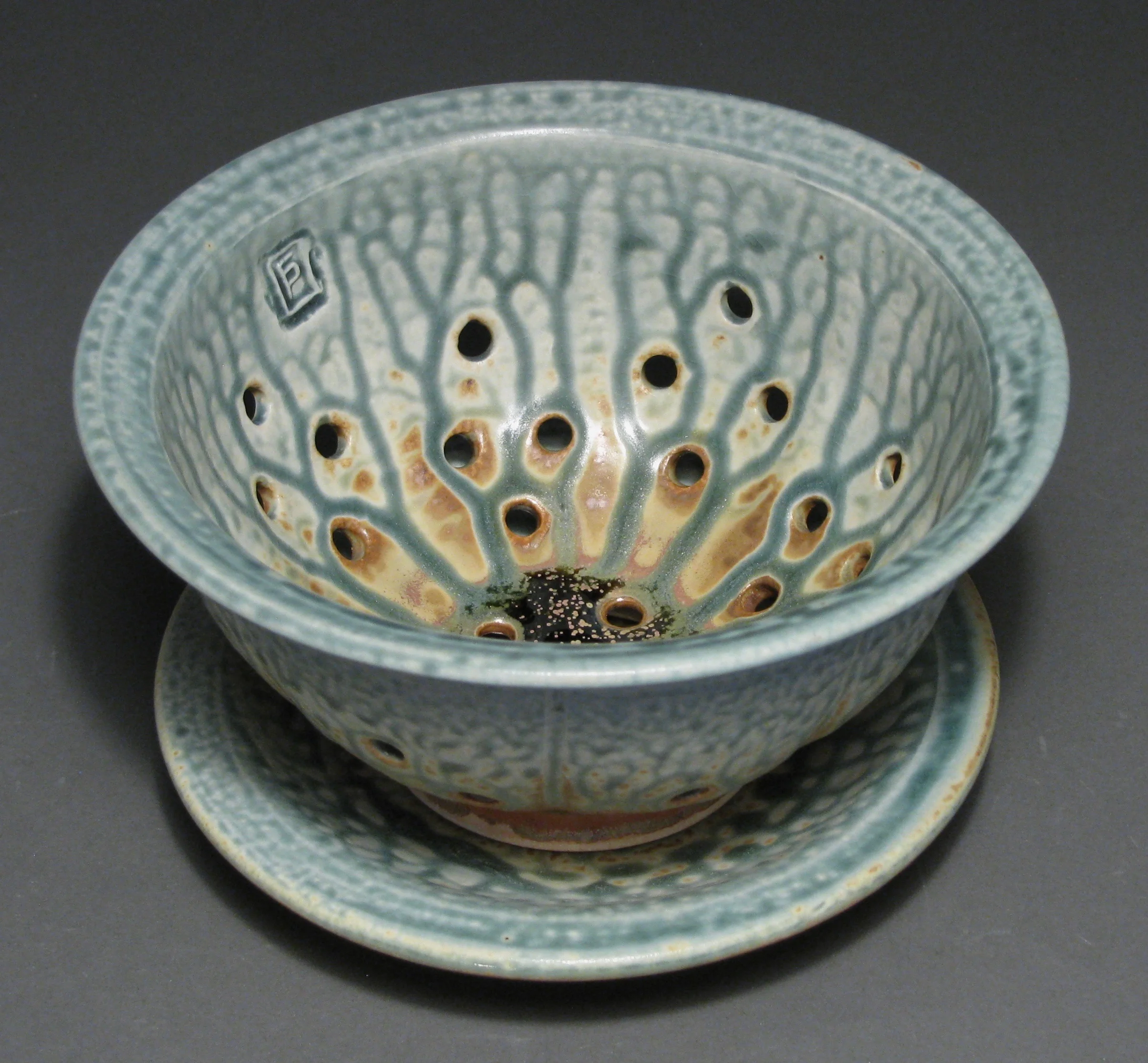 Berry bowl 7" diameter Glazes: blue ash and matte rust