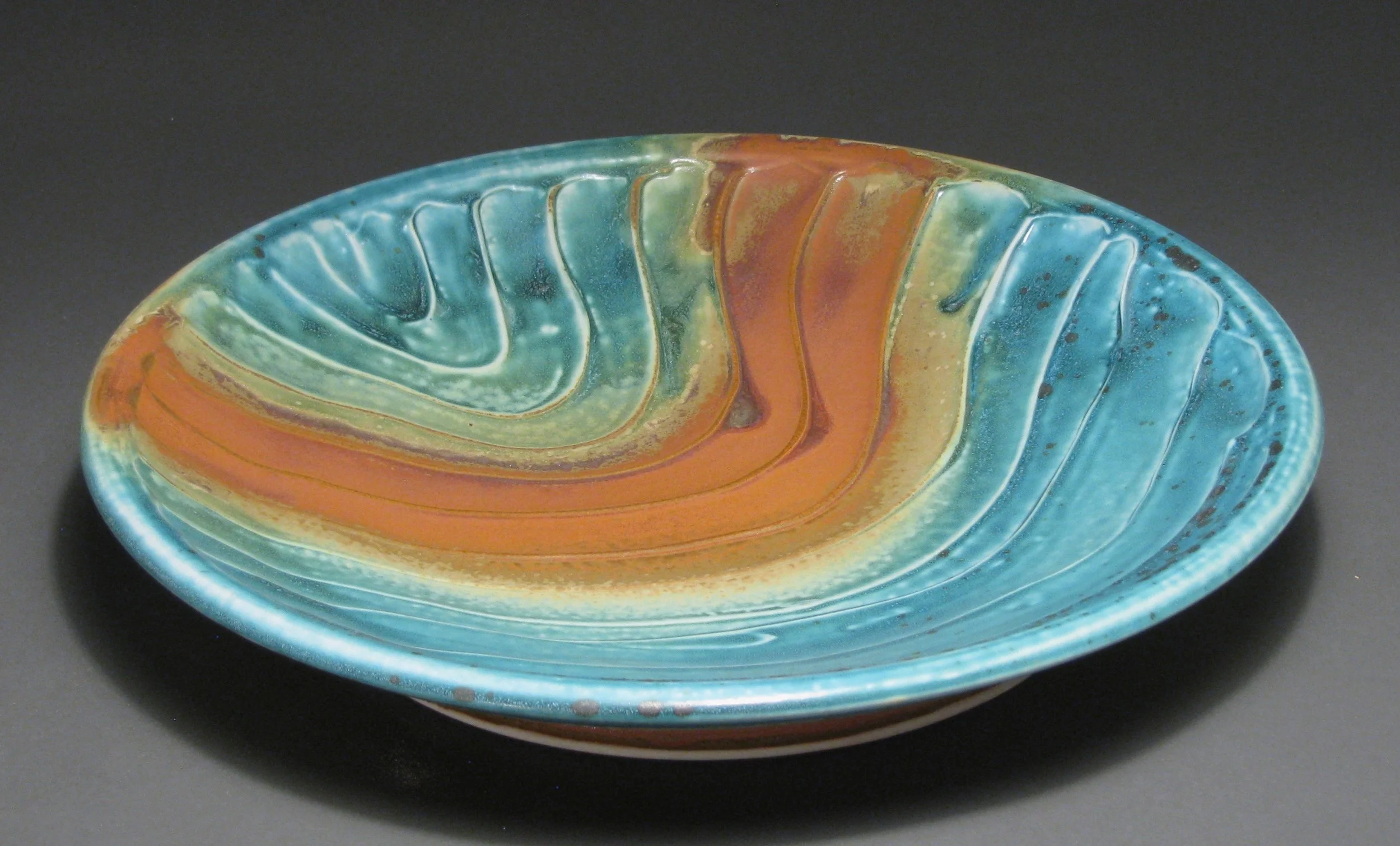 Serving platter/bowl with “slipped” texture 14" diameter Glazes: matte turquoise and matte rust