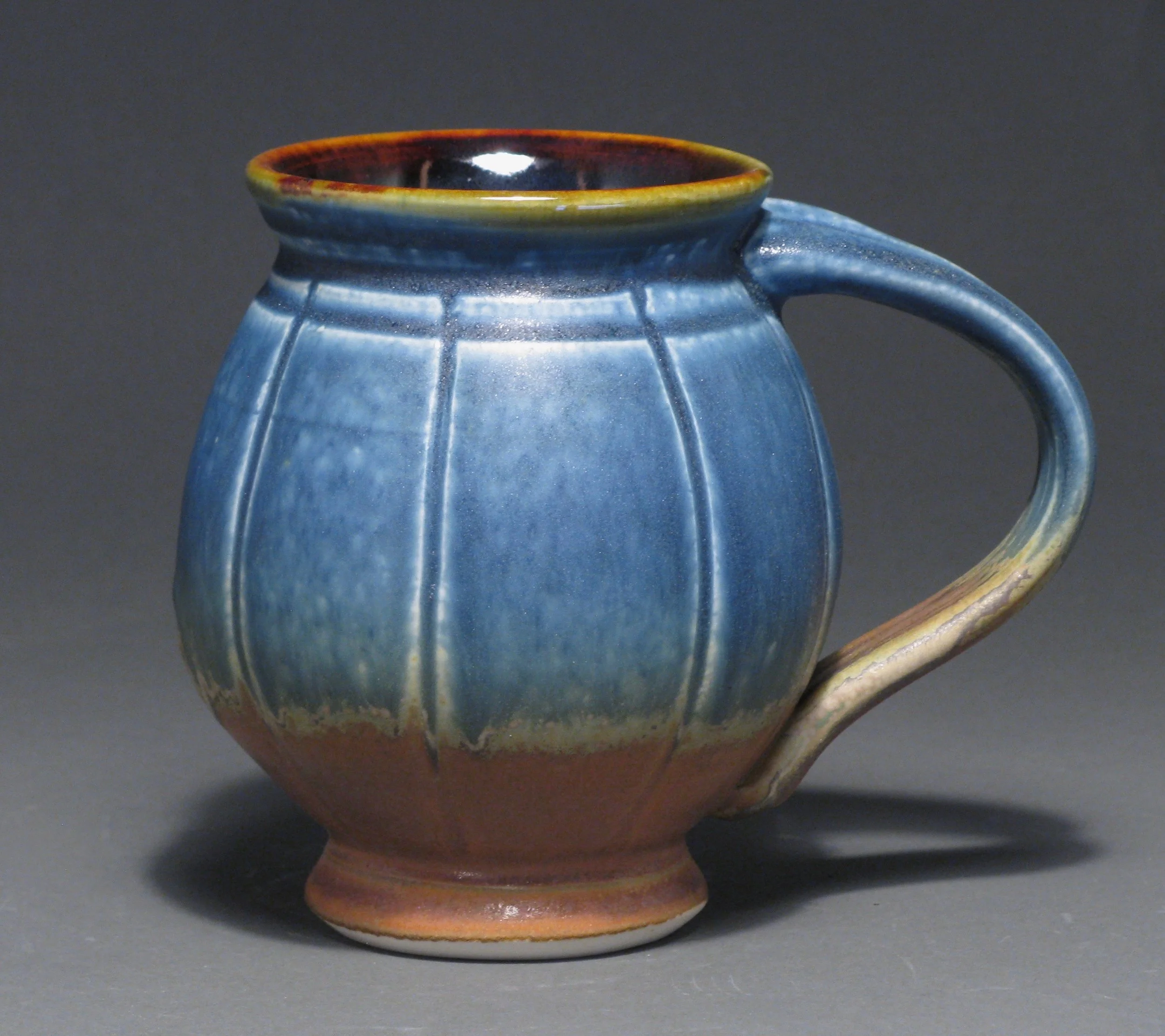 Round bellied mug 5" tall Glazes: matte blue and matte rust