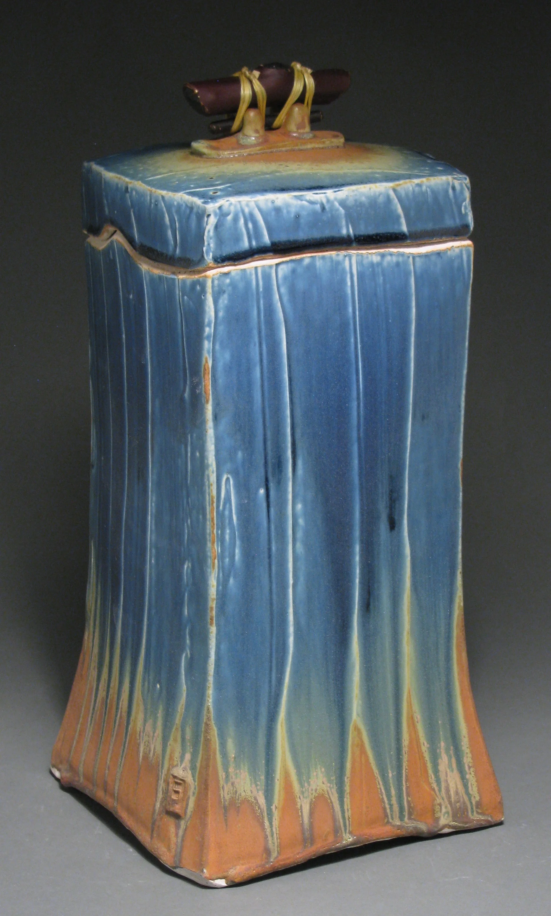 Lidded box or funerary urn 13 1/4" tall by 6 1/4" deep by 6 1/4" wide Glazes: Mixed blue and matte rust