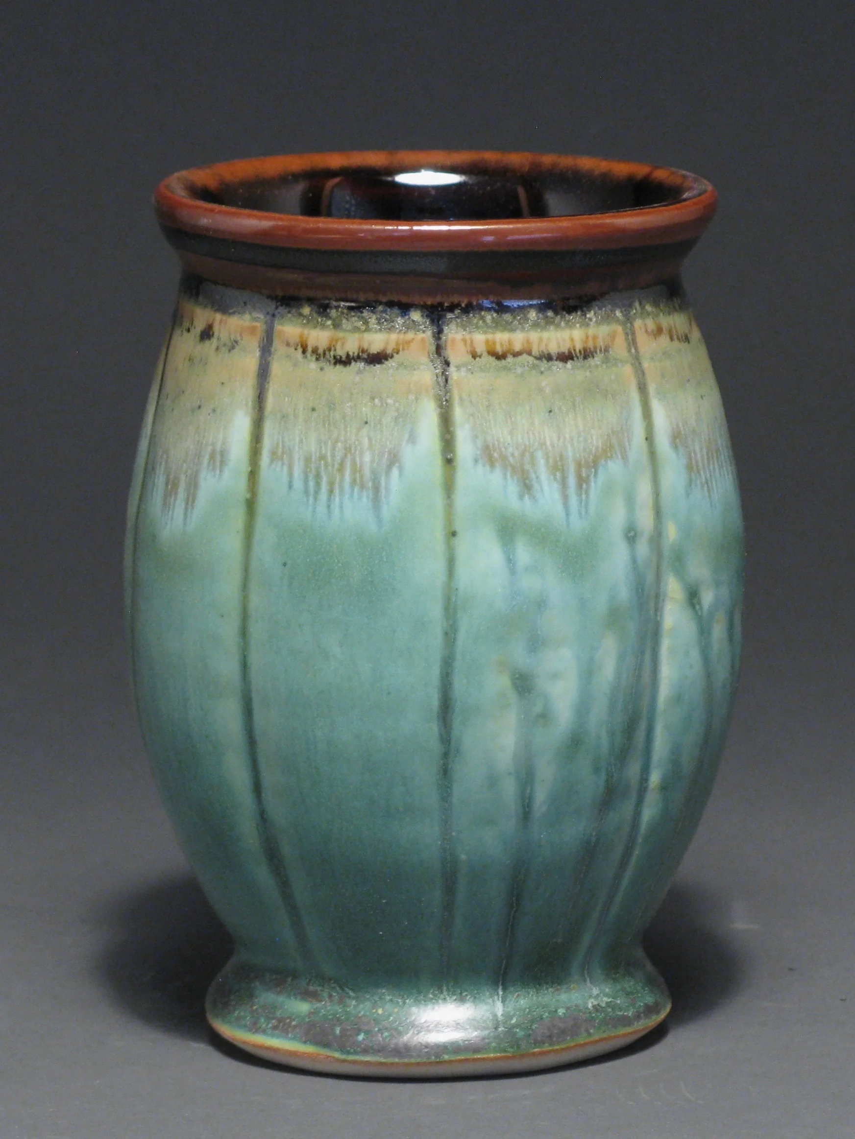 Tumbler 5 1/2” tall Glazes: Patina green and temmoku