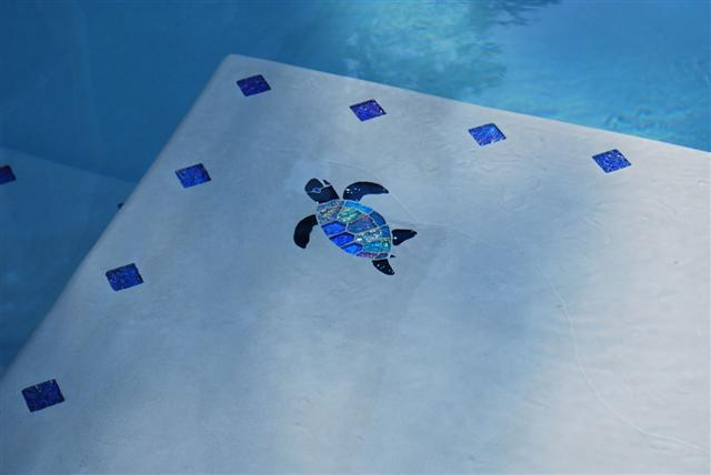 Close up of small mosaic installations in the shallow end of the pool.