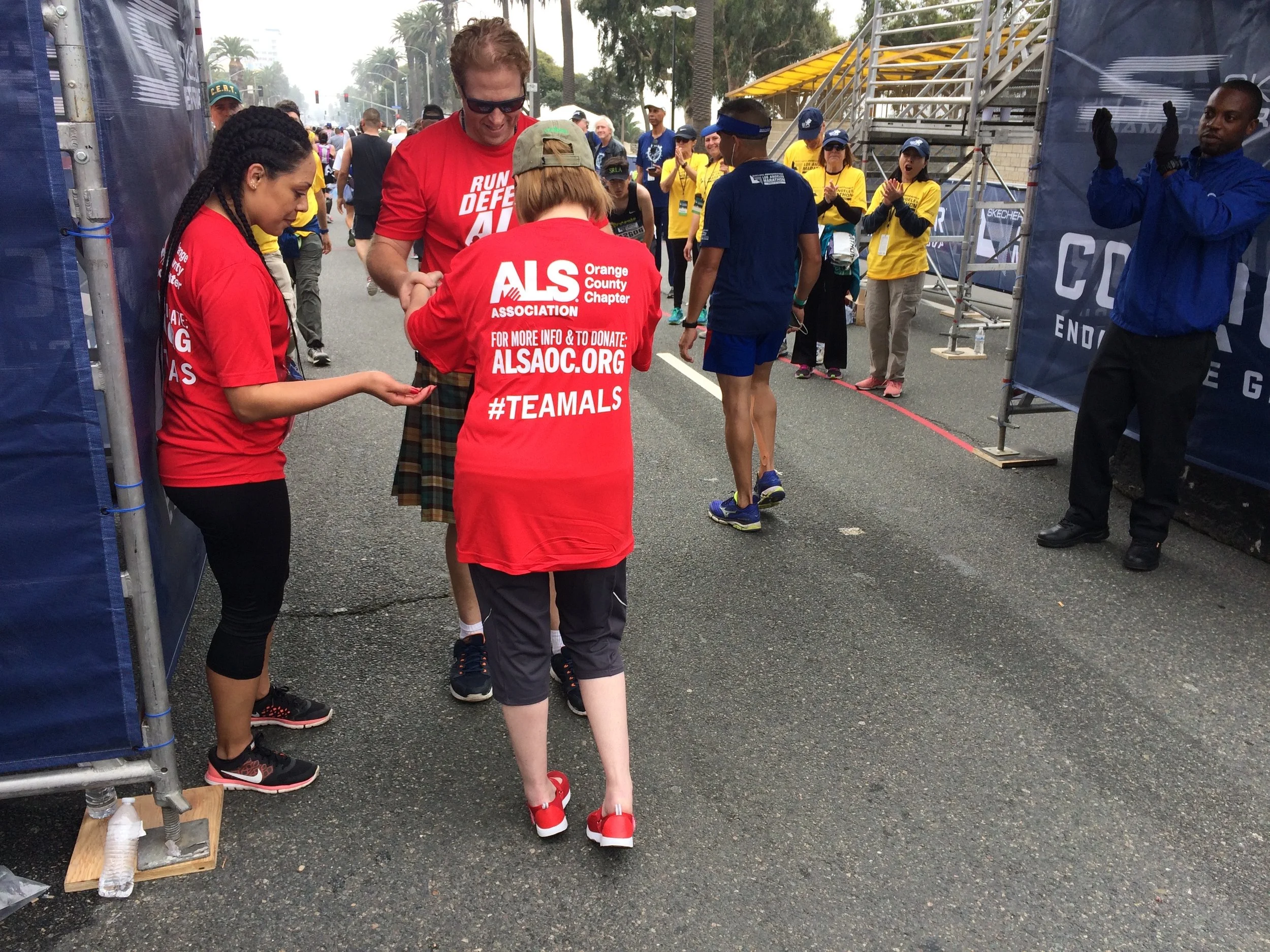 Eryn Blythe nears the finish line with the support of her husband, Chad. (Photo by Loud Owl)