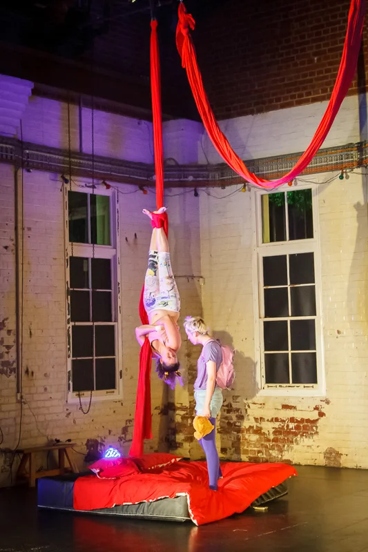 Lara Croydon (Performer—The Orphan), upside down, and Sarah McLeod (Performer—The Stranger), standing, in Learning to Love Gravity at Brisbane’s Powerhouse, 10 th May 2015. Picture credit: Geoff Lawrence .