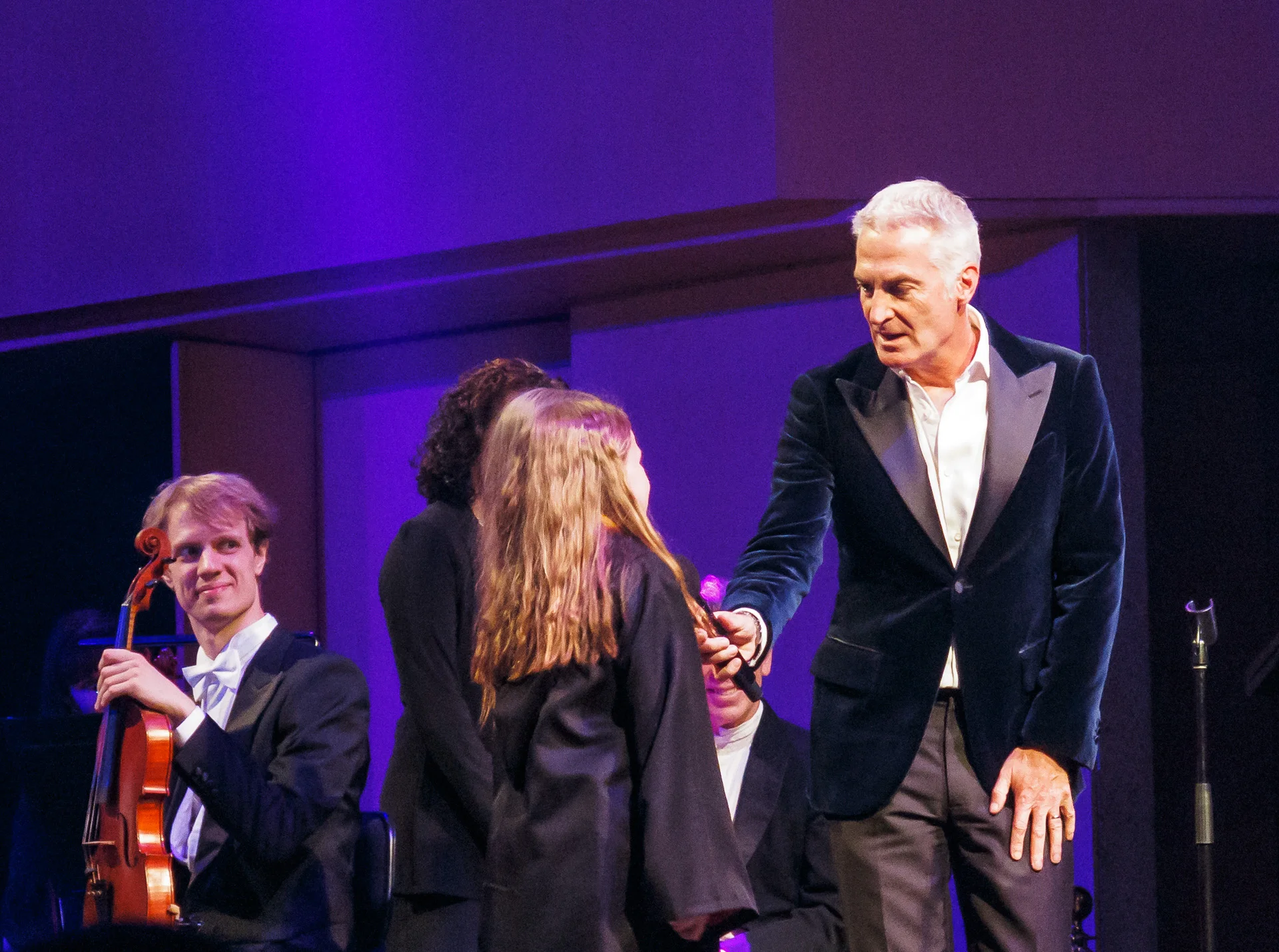Pictured: Andrew Lofthouse, greeting the first storytellers of the evening ('including ‘Hermione’). Picture credit: Creative Futures Photography.