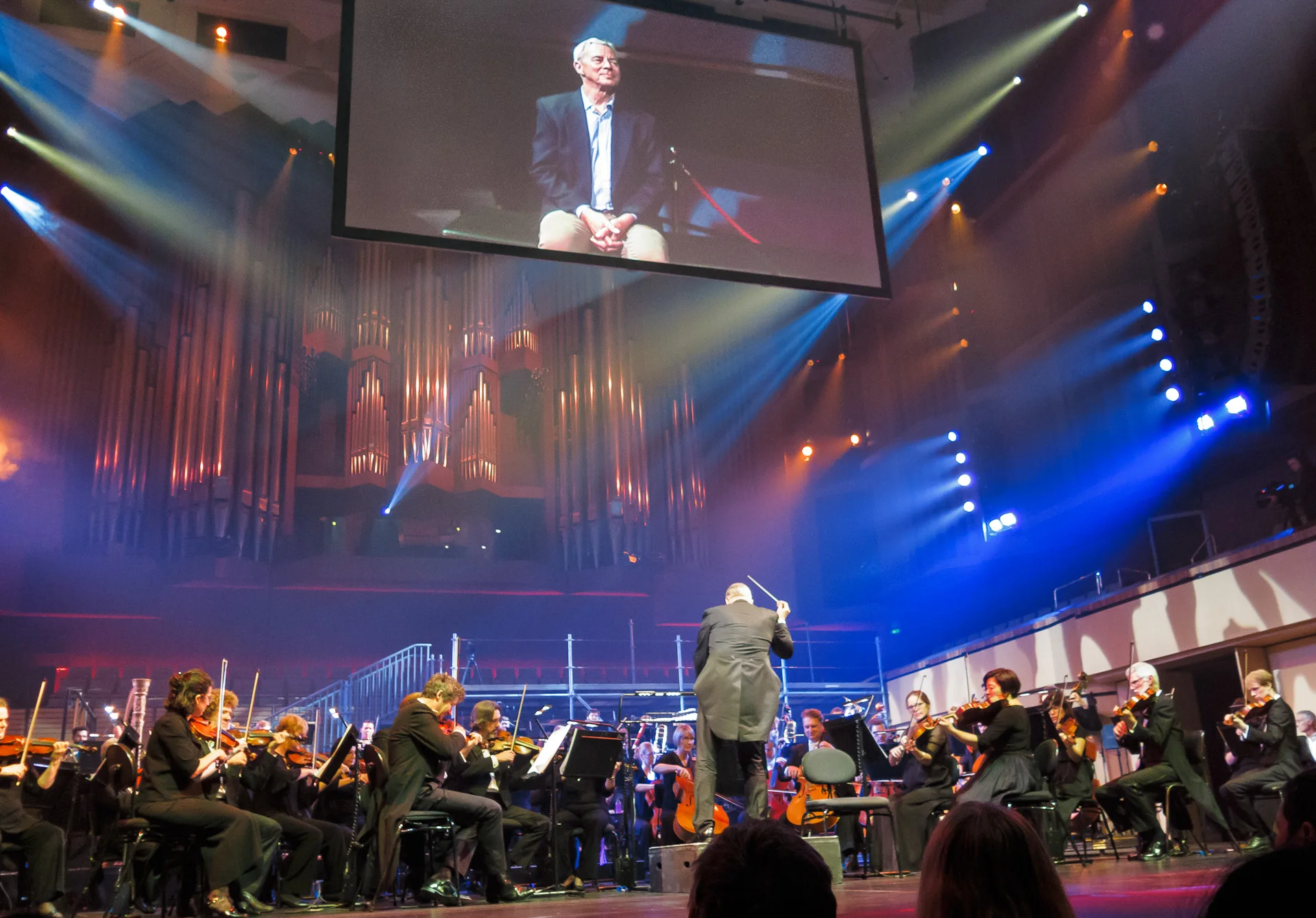 Pictured: Karl (on the big screen), listening to the fourth movement from Tchaikovsky ’s Symphony No.7 (completed by Semyon Bogatyrev). Picture credit: Creative Futures Photography.