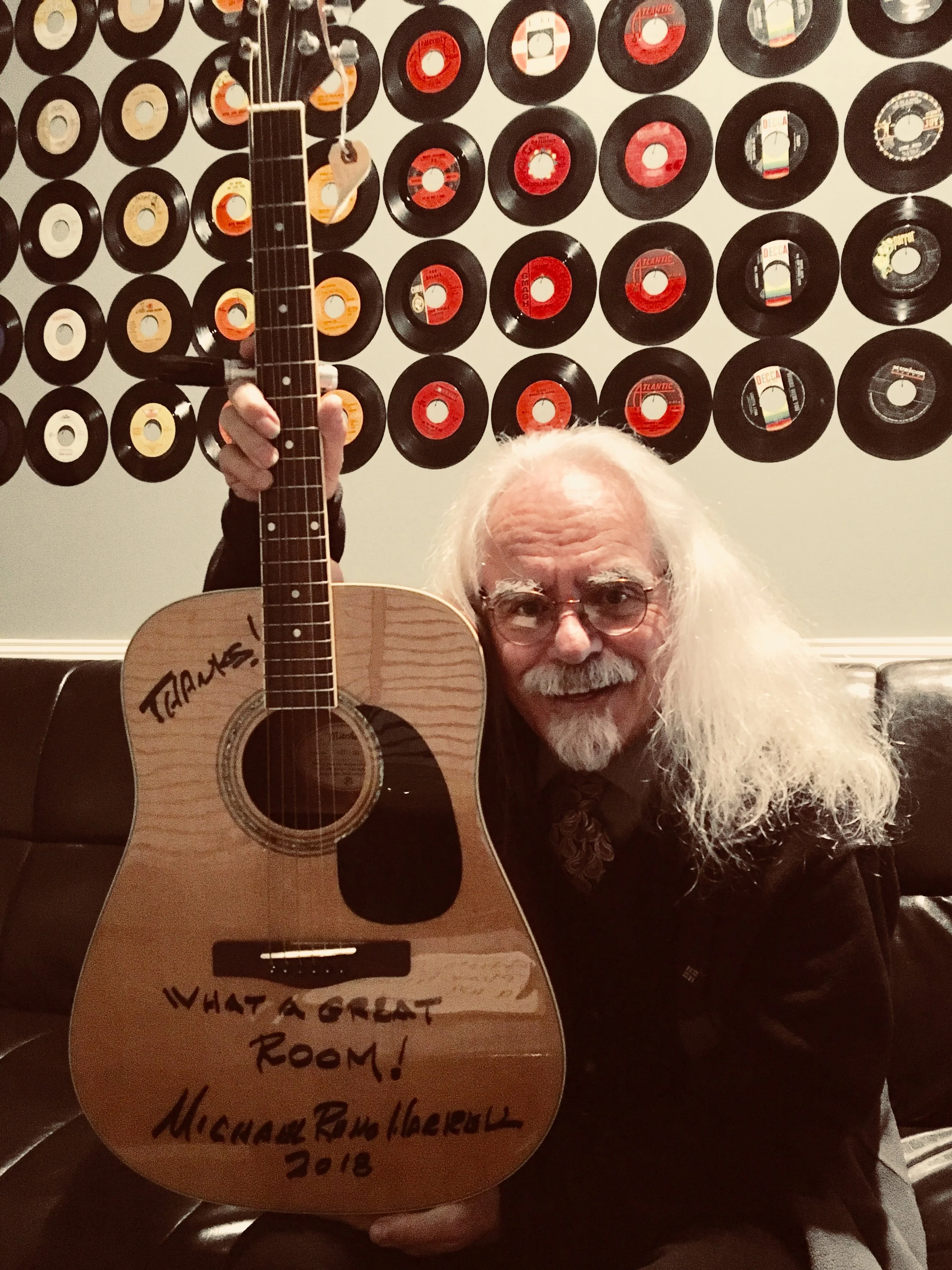 Michael Reno Harrell in the green room with his signed guitar.
