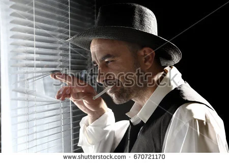 stock-photo-a-private-detective-in-his-office-670721170.jpg