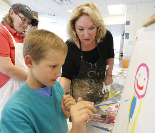Fairhope artist B'Beth Weldon watches as A.J. Smith paints a self portrait at USA Children's & Women's Hospital Wednesday, Sept. 25, 2013. Weldon brought her Gifted Masterpieces program to the hospital Wednesday. Children receiving treatment at the USA Mitchell Cancer Institute and their families took a break from their normal routines to paint masterpieces.