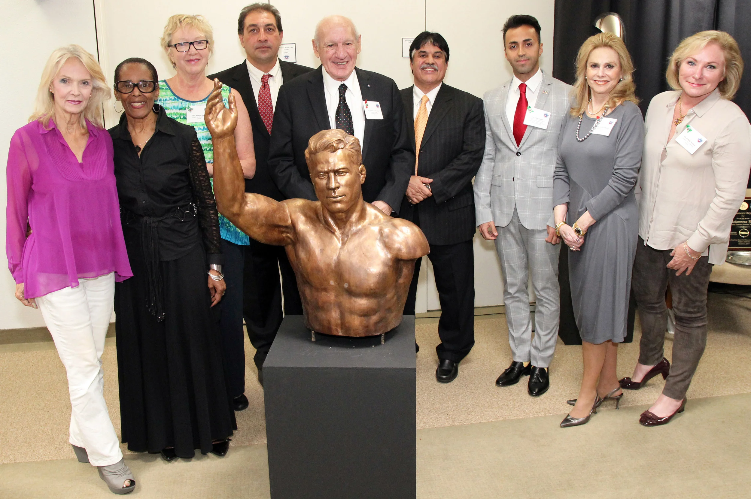 From left are United States Sports Academy’s Art Committee members Kay Daughdrill; B.J. Cooper; and chair Nancy Raia; Babak Takhti, son of the late Jahan Pahlavan Takhti; Academy Founding President and committee member Dr. Thomas P. Rosandich; Ebrahim Maghsoud, NAIFS President and President of the Hafez Corp. in Mobile; Vahid Abideh, NAIFS Founder and CEO and Secretary General of Iran’s Young Journalists Society; committee member emerita and Academy Trustee Susan McCollough; and committee member B’Beth Weldon with sculpture of legendary Iranian wrestler Jahan Pahlavan Takhti presented to the American Sport Art Museum & Archives (ASAMA) by the North American Iranian Friendship Society (NAIFS). USSA.EDU, ASAMA.ORG
