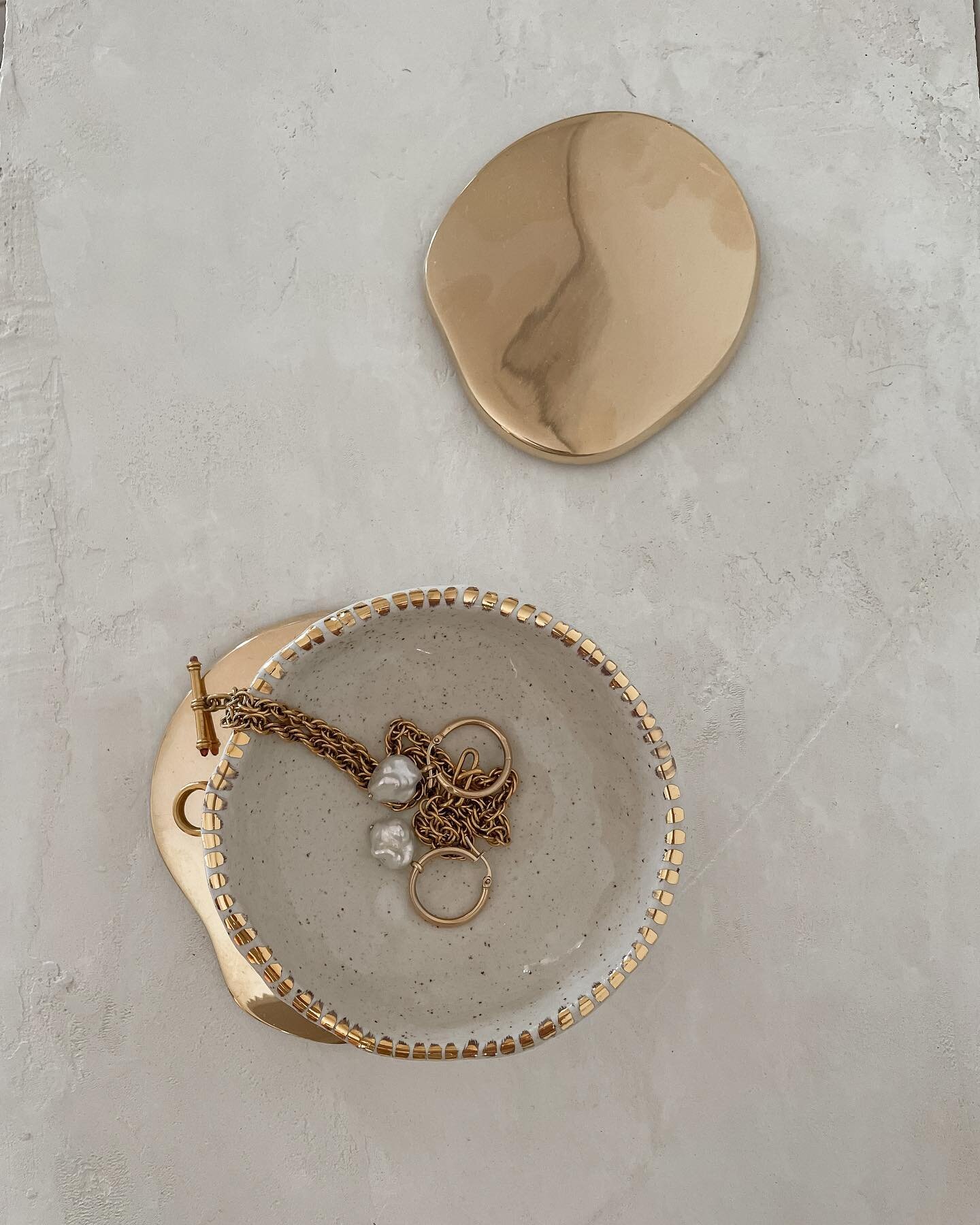 Obsessed with these new Golden Hour Trinket Dishes. Pinched from a speckled stoneware, dipped in a milky-white glaze and hand painted with 18ct gold.

Perfect to house your precious jewels, or use on the table with salt, olives or condiments.

Online