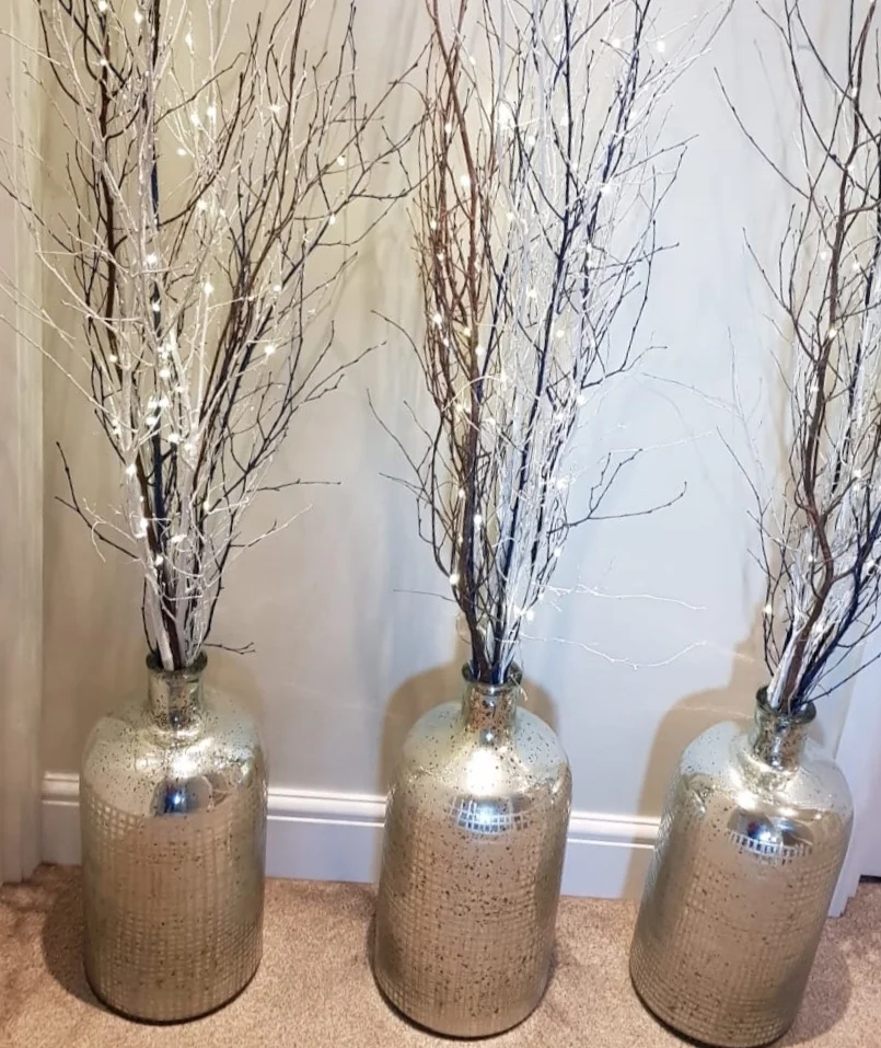 Stunning large silver mirrored textured display vases. Three available. £18 each to hire. Decorative twigs with LED fairy lights also available