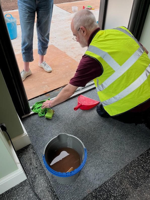 Cleaning beneath the entrance threshold removing plaster and clay.