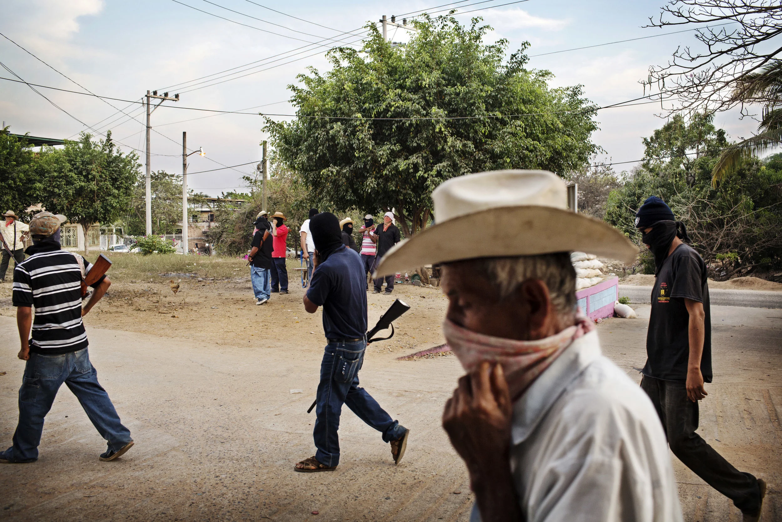 A group of vigilantes are patrolling the small town of El Cortijo.