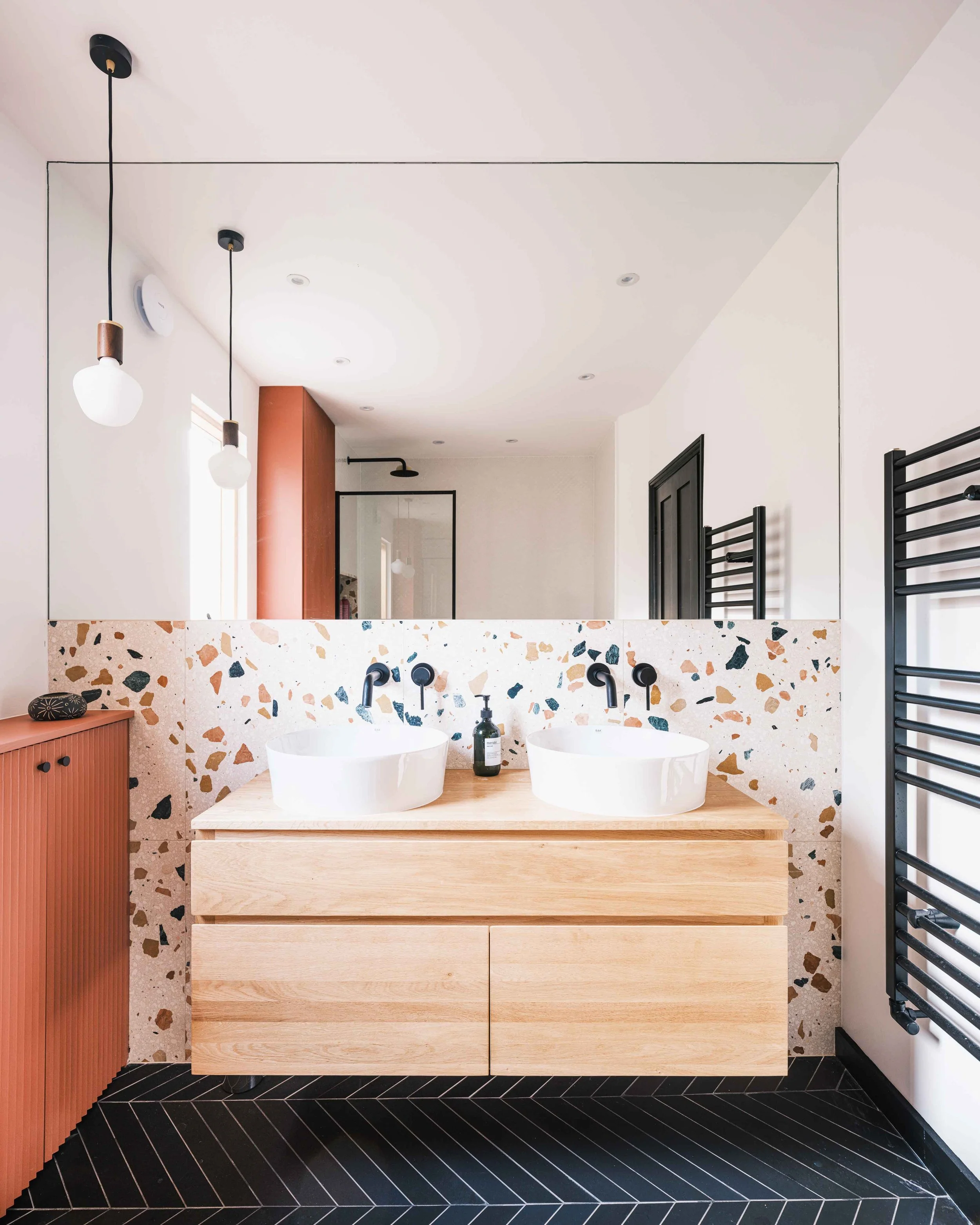Bold terrazzo tiles and terracotta joinery