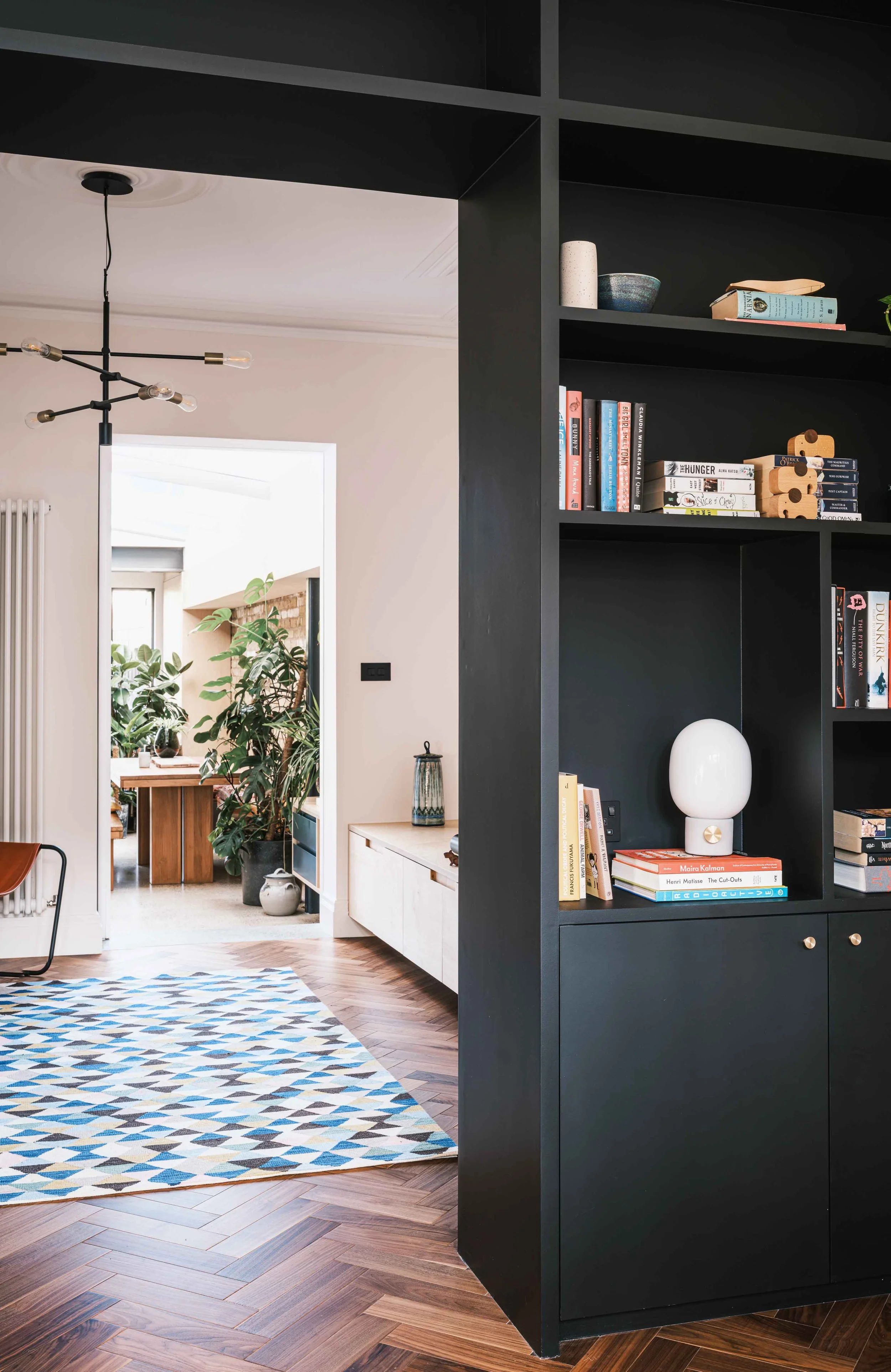 Bespoke black shelving and walnut floor