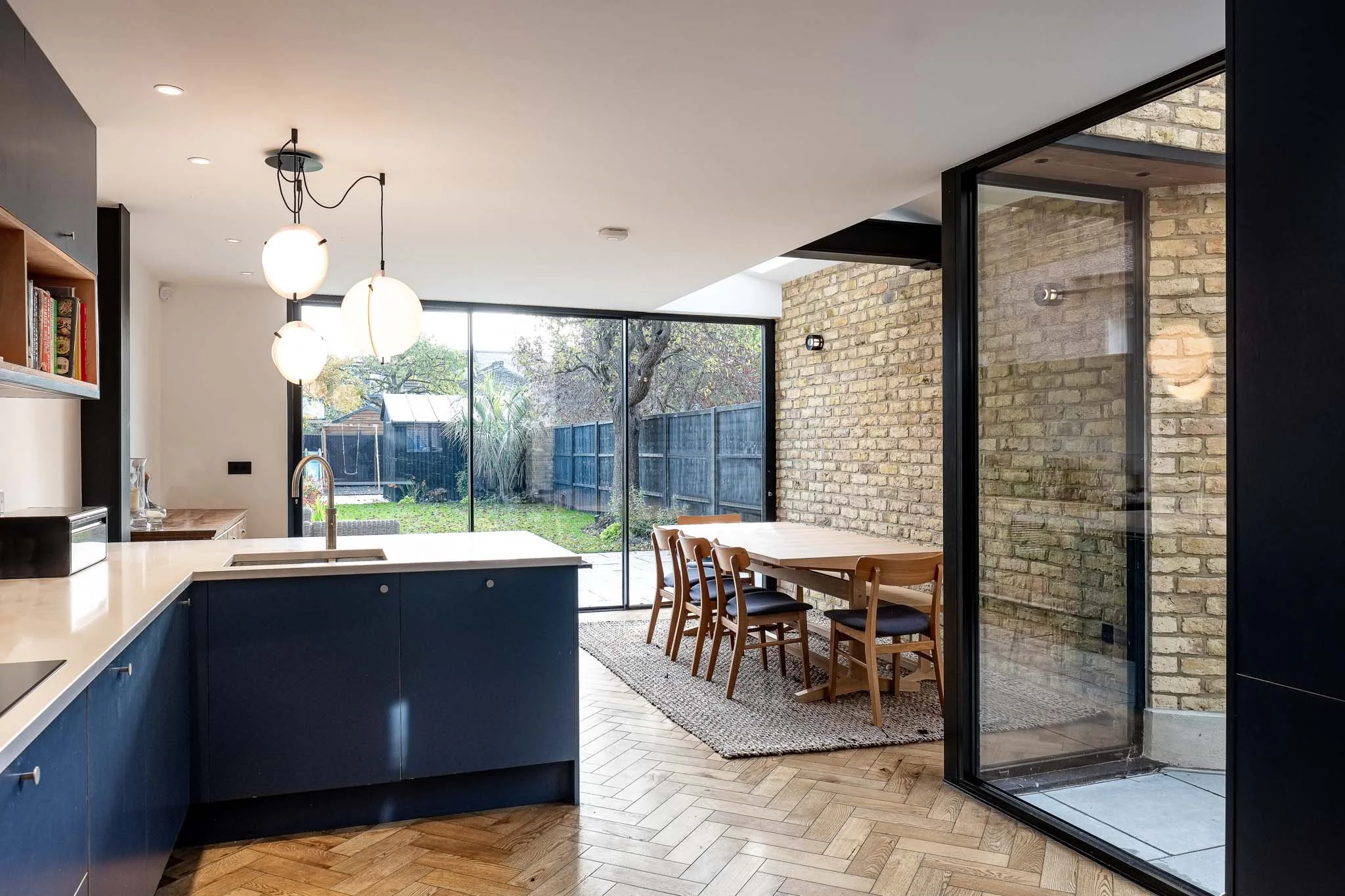 Kitchen extension with corner glazing and exposed brick
