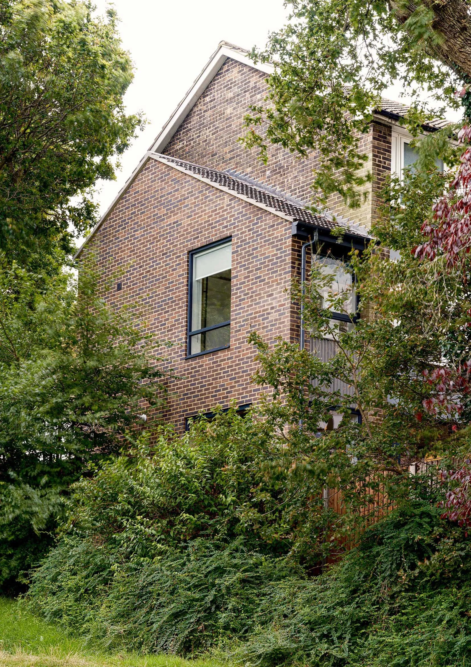 Two storey extension with large windows overlooking park