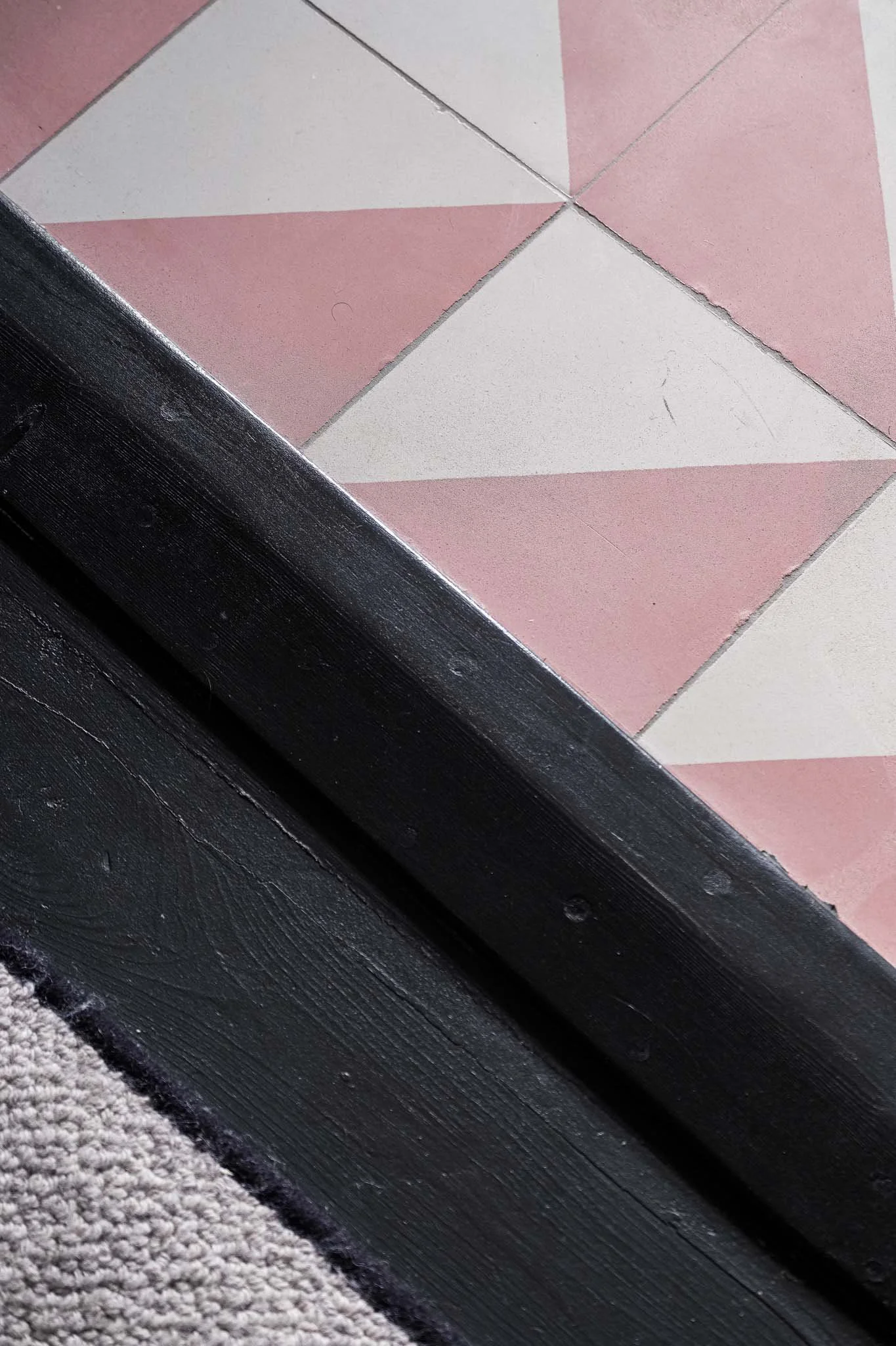 Pink encaustic tile and floor threshold