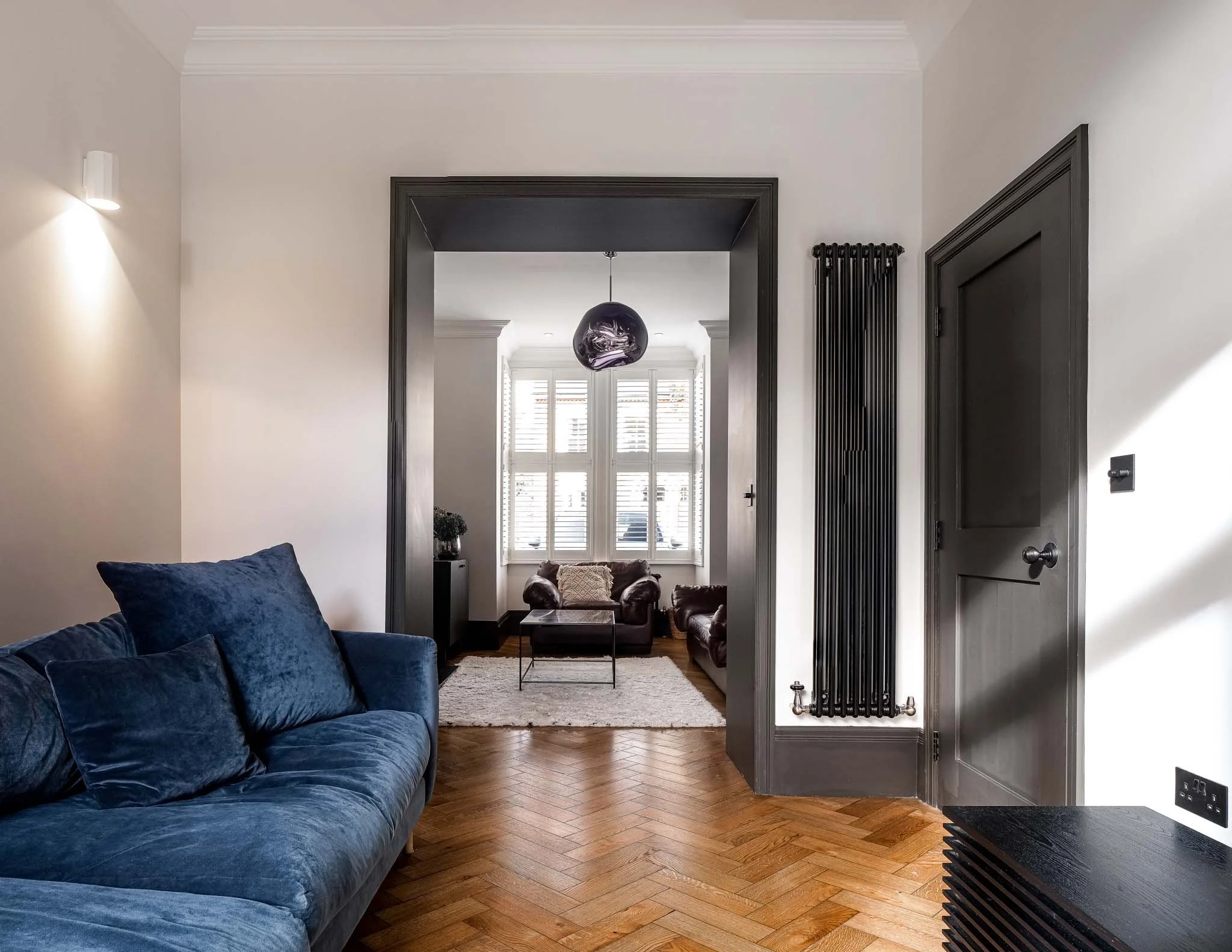 Polished oak herringbone floor with dark woodwork