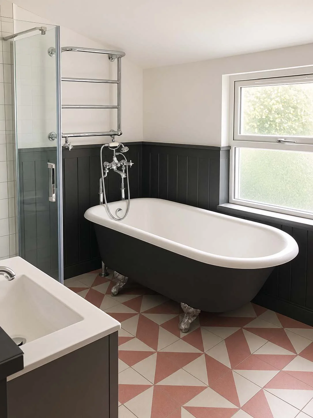 Geometric pink tiles and claw foot bathtub