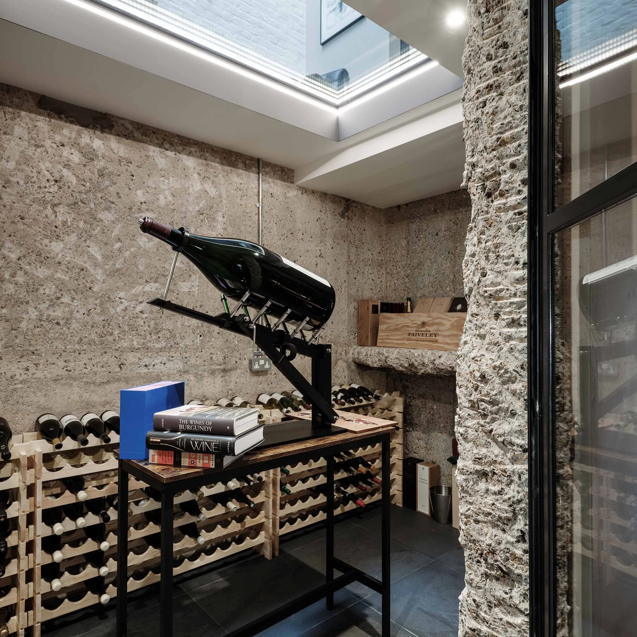 Integrated wine cellar with exposed concrete walls