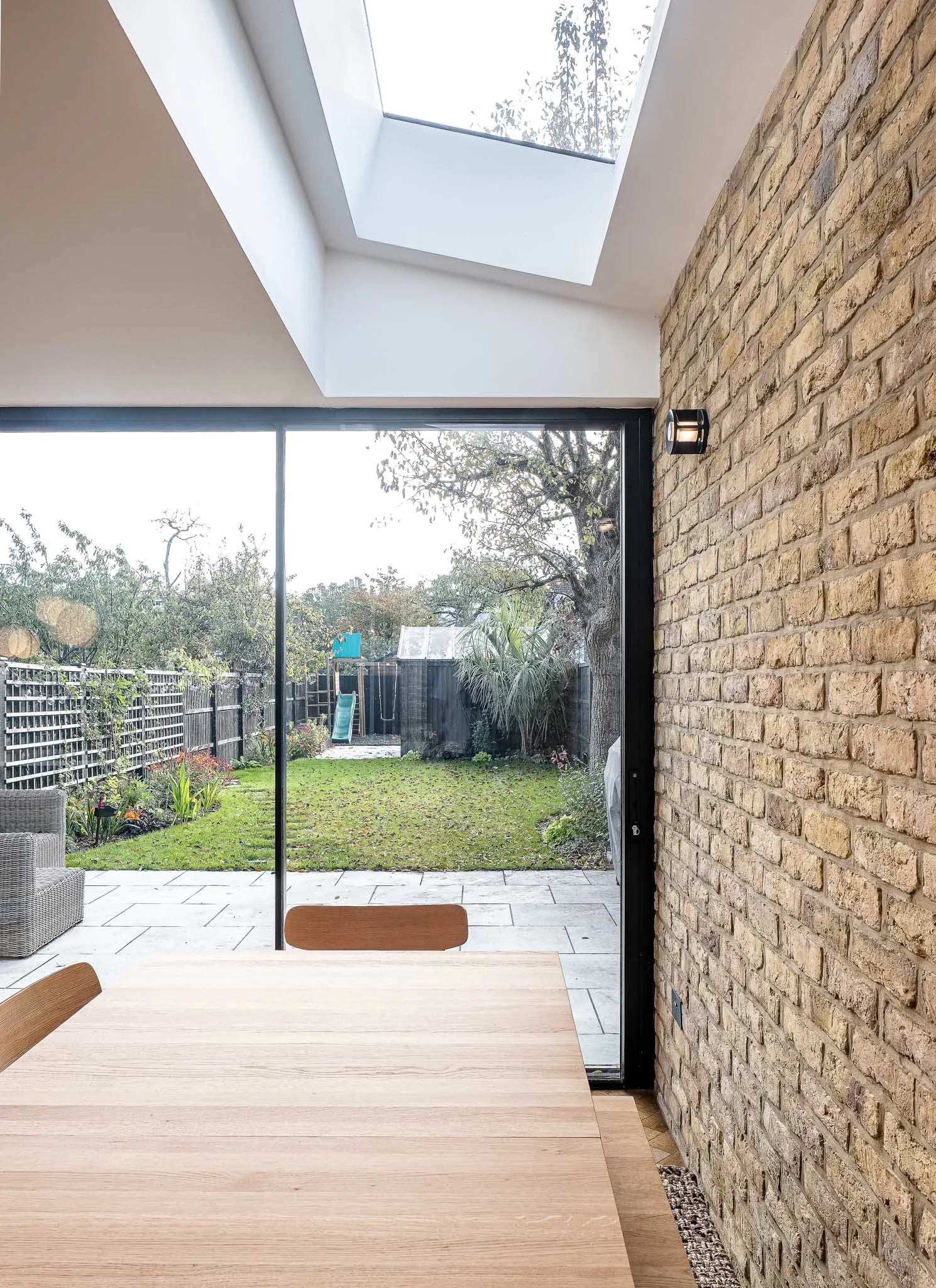 Large sliding doors and rooflight with exposed brickwork