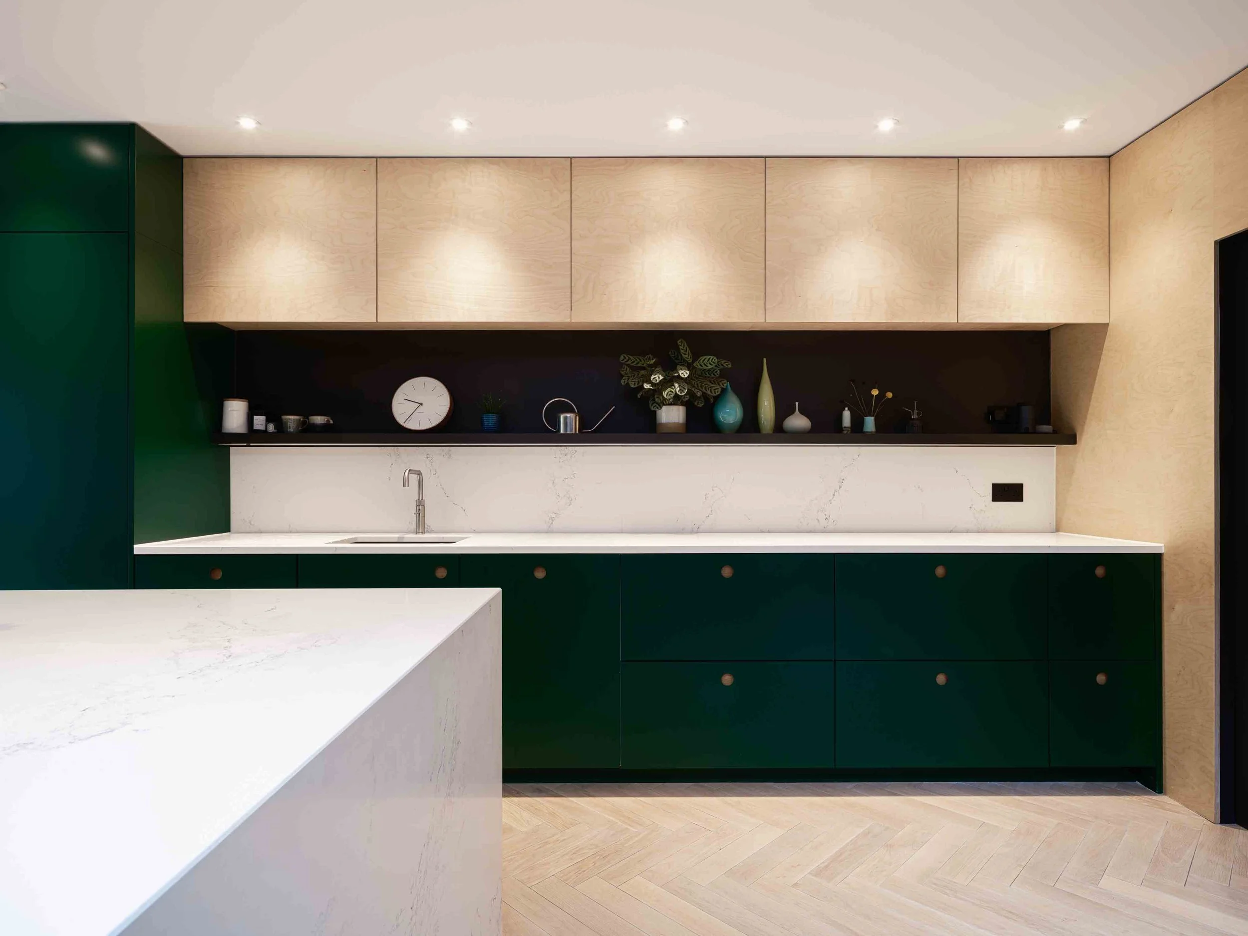 Bespoke kitchen design with green cabinets and plywood